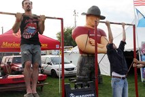 Concert-goers compete in an impromptu pull up competition at RockFest 2014 in Cadott, Wisconsin. During the music festival, fans of Aerosmith and Rob Zombie conducted pull ups with the RS Twin Cities Marines.