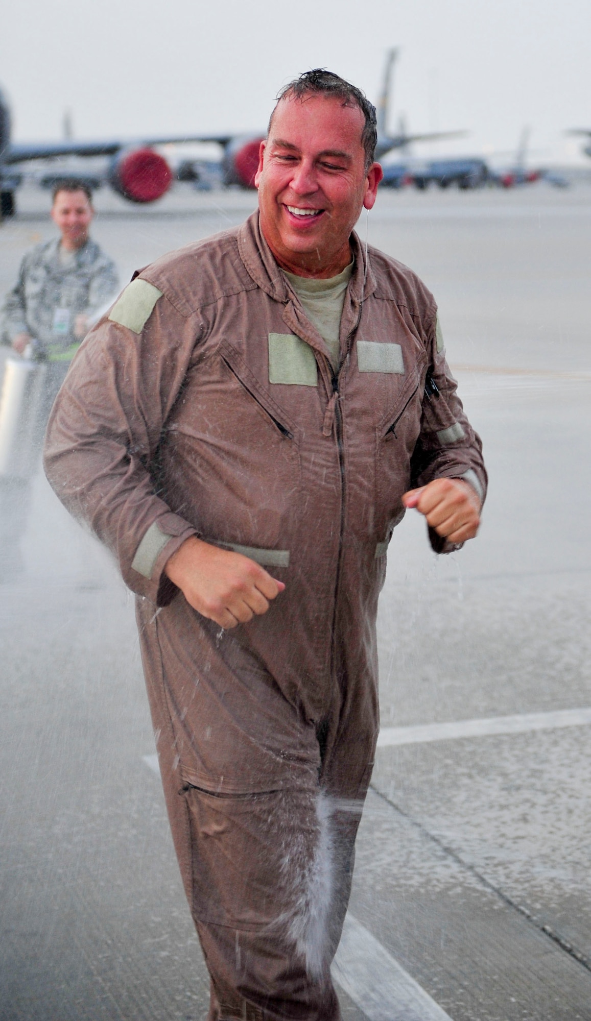 Senior Master Sgt. Floyd W. Atkins  is hosed down after reaching his 8,000 flight hour mark  July 17, 2014, on Al Udeid Air Base, Qatar.  Atkins is a boom operator with the 340th Expeditionary Air Refueling Squadron. He is deployed from the 151st Air Refueling Squadron, Tennessee Air National Guard. Boom operators typically only reach 5,000-6,000 refueling hours in their career. (U.S. Air Force photo/Senior Airman Colin Cates)