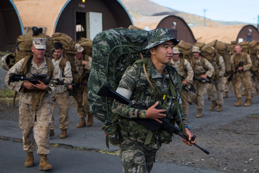POHAKULOA TRAINING AREA, Hawaii - A Republic of Korea marine departs with Combined Landing Team 3 from base camp on a 15 km hike to Range 1 to stage for upcoming training during the Rim of the Pacific (RIMPAC) Exercise 2014 at Pohakuloa Training Area, Hawaii, July 18, 2014. Combined Landing Team 3 will participate in numerous ranges to further enhance their capability and proficiency while attending PTA. Twenty-two nations, more than 40 ships and submarines, about 200 aircraft and 25,000 personnel are partcipating in RIMPAC from June 26 to Aug. 1 in and around the Hawaiian Island and Southern California. The world’s largest international maritime exercise, RIMPAC provides a unique training opportunity that helps foster and sustain the cooperative relationships that are critical to ensuring the safety of sea lanes and security on the world’s oceans. RIMPAC 2014 is the 24th exercise in the series that began in 1971. (U.S. Marine Corps photo by Lance Cpl. Wesley Timm/Released)
