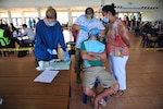 NEIAFU, Vava'u  (July 22, 2014) - U.S. Air Force Capt. Jeremy Matis, a dentist, and Royal Australian Air Force Corporal Terri-Anne Dehncke, senior dental assistant-preventative, perform an extraction.  The dental clinic was set up in a local college for the Pacific Angel-Tonga healthcare services outreach. Matis is deployed from Eielson Air Force Base, Alaska and Dehncke is from RAAF Base Richmond, New South Wales. 140722-HQ302-071

