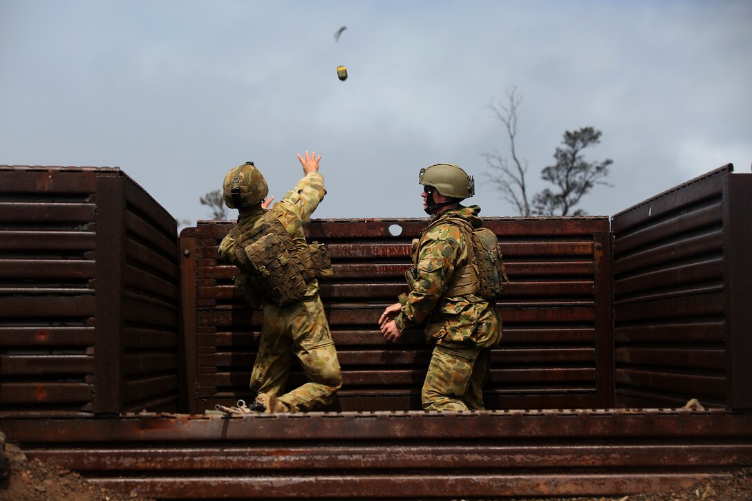 POHAKULOA TRAINING AREA, Hawaii - Australian Army soldiers with Company Landing Team 2 throw a grenade at Range 5C in Pohakuloa Training Area, Hawaii, July 20, during Rim of the Pacific (RIMPAC) Exercise 2014. Twenty-two nations, more than 40 ships and submarines, about 200 aircraft and 25,000 personnel are participating in RIMPAC from June 26 to Aug. 1 in and around the Hawaiian Islands and Southern California. The world's largest international maritime exercise, RIMPAC provides a unique training opportunity that helps participants foster and sustain the cooperative relationships that are critical to ensuring the safety of sea lanes and security on the world's oceans. RIMPAC 2014 is the 24th exercise in the series that began in 1971. (Photo by Sgt. Sarah Dietz/Released)