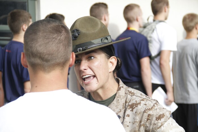 Sergeant Lindsey Rodriguez, a Company O, 4th Recruit Training Battalion, Marine Corps Recruit Depot Parris Island drill instructor, instructs a poolee to clarify his response to her as "ma'am" whenever he walks past at Recruiting Station Kansas City's all-hands pool function at Camp Clark, June 20, 2014.