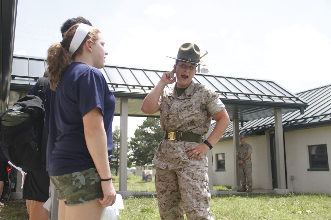 Sergeant Lindsey Rodriguez, a Company O, 4th Recruit Training Battalion, Marine Corps Recruit Depot Parris Island drill instructor, waits to hear increased volume from poolees during Recruiting Station Kansas City's all-hands pool function at Camp Clark in Nevada, Mo., June 20, 2014.