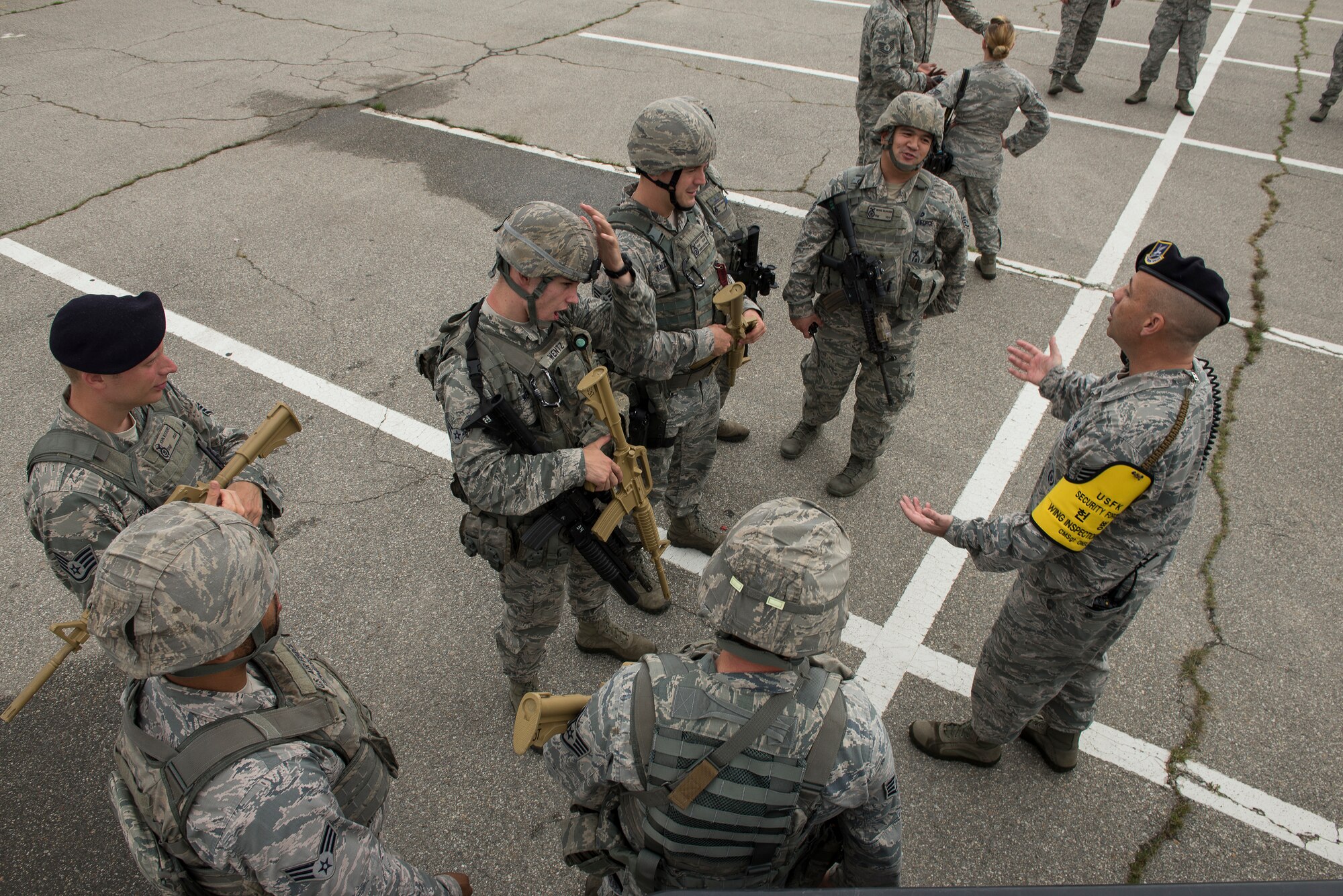 Chief Master Sgt. James ONeil, 51st Security Forces Squadron wing inspection team, talks to Airmen about the exercise during a "pause-ex" July 24, 2014, at Osan Air Base, Republic of Korea. Pausing an exercise gives responders and performers a chance to get direct feedback on their performance, and better prepare them to respond in real-world emergencies. (U.S. Air Force photo by Staff Sgt. Jake Barreiro)