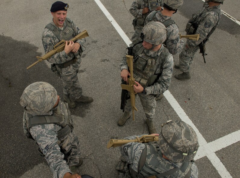 Emergency responders talk during a "pause-ex" during an exercise hostage scenario July 24, 2014, at Osan Air Base, Republic of Korea. During exercise Beverly Midnight 14-03, Airmen from around the base were tested on effective emergency response, recovery and base defense. (U.S. Air Force photo by Staff Sgt. Jake Barreiro)