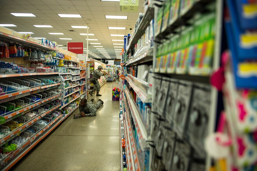 A 51st Security Forces Squadron responder sweeps the Base Exchange during an active-shooter exercise July 24, 2014, at Osan Air Base, Republic of Korea. The exercise tested emergency, recovery and defense personnel on their capablities to work through a disasterous situation. (U.S. Air Force photo by Staff Sgt. Jake Barreiro)