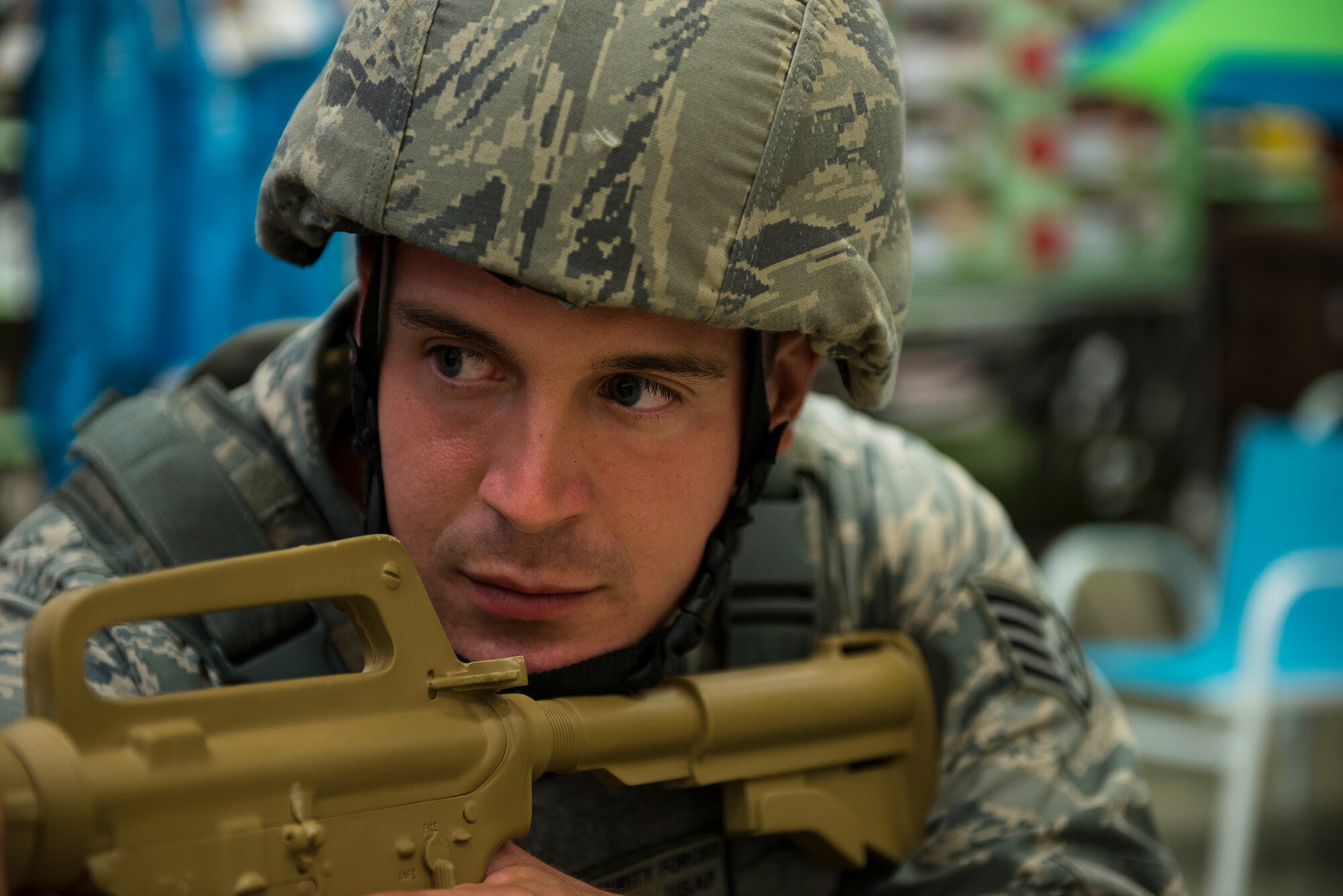 Staff Sgt. Joseph Kaczynski, 51st Security Forces Squadron emergency responder, surveys the scene during an active-shooter exercise July 24, 2014, at Osan Air Base, Republic of Korea. The scenario included two gunmen running through the Base Exchange. (U.S. Air Force photo by Staff Sgt. Jake Barreiro)