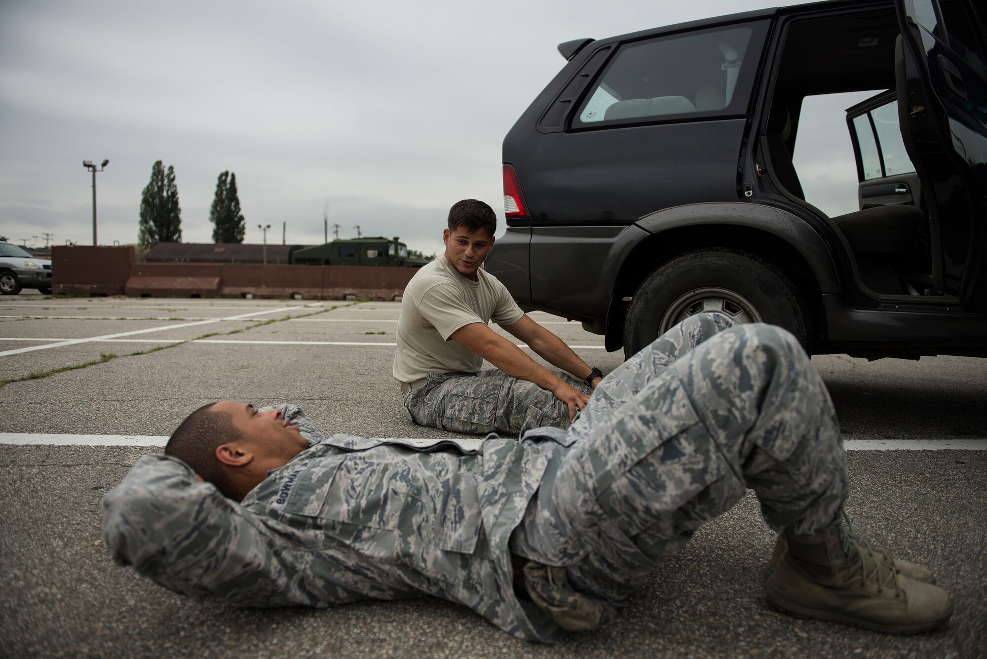 Simulated gunmen rest during a "pause-ex" during a hostage and active-shooter exericse July 24, 2014, at Osan Air Base, Republic of Korea. The exercise includes injects and feedback from members on the Wing Inspection Team in order to give personnel real time feedback on their performance. (U.S. Air Force photo by Staff Sgt. Jake Barreiro)