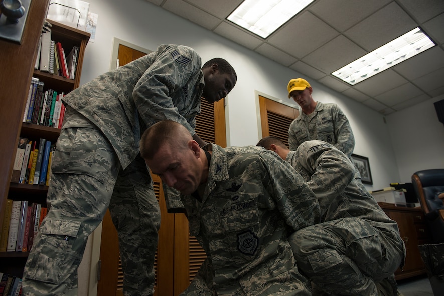 Simulated gunmen bind a hostate during an active-shooter exercise July 24, 2014, at Osan Air Base, Republic of Korea. During the exercise, hostages were taken to test Security Forces response capabilities. (U.S. Air Force photo by Staff Sgt. Jake Barreiro)