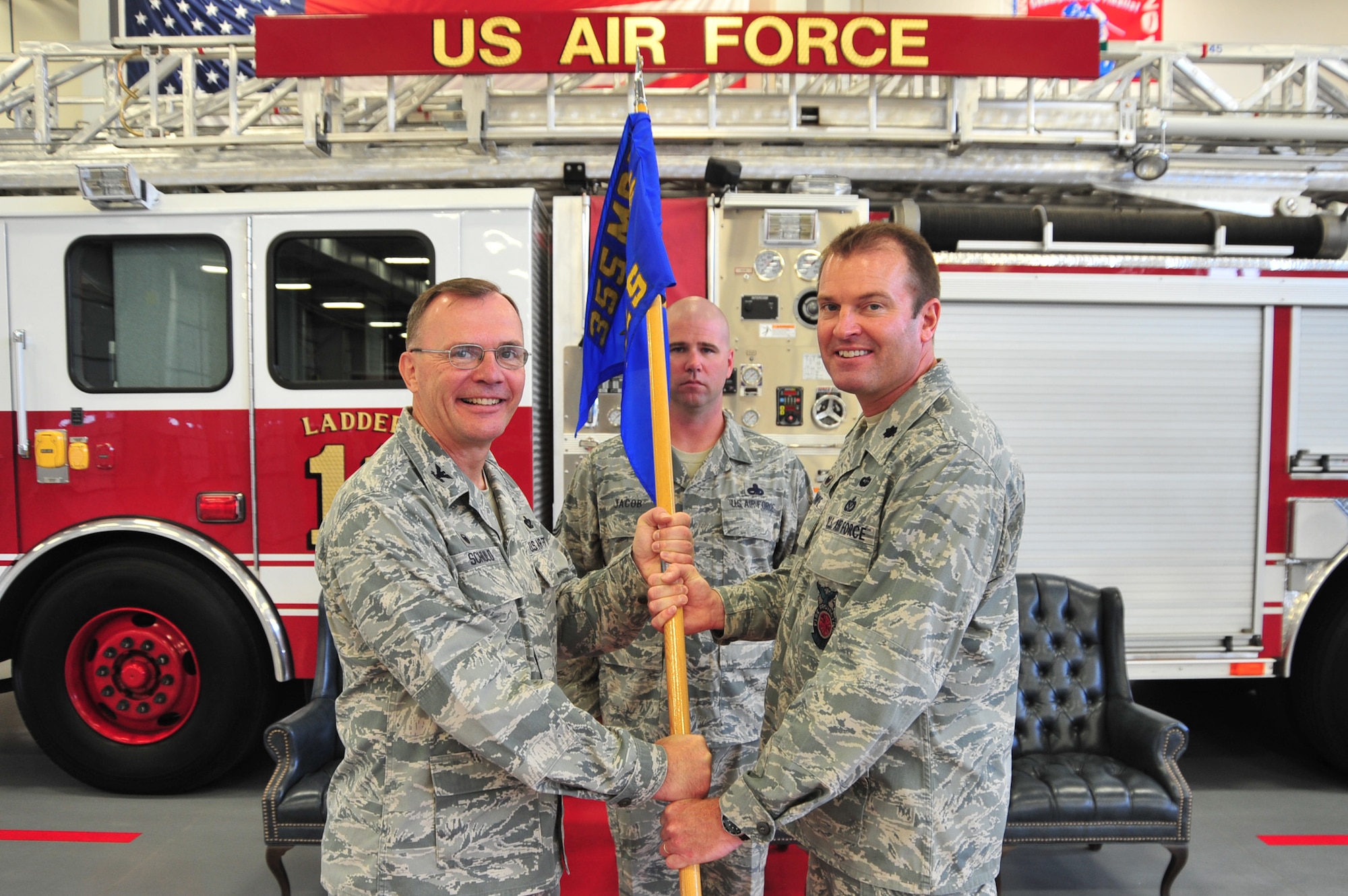 U.S. Air Force Lt. Col. Brian M. Stumpe accepts the 355th Civil Engineer Squadron guidon from Col. Rodger G. Schuld, 355th Mission Support Group commander, during a change of command ceremony at Davis-Monthan Air Force Base, Ariz., July 24, 2014.  The passing of the guidon is a traditional military custom signifying the transfer of command, thereby signifying Stumpe’s new role as the 355th CES commander.  Stumpe assumed command of the 355th CES from Lt. Col. John E. Tryon. (U.S. Air Force Photo by Airman 1st Class Chris Massey/Released)