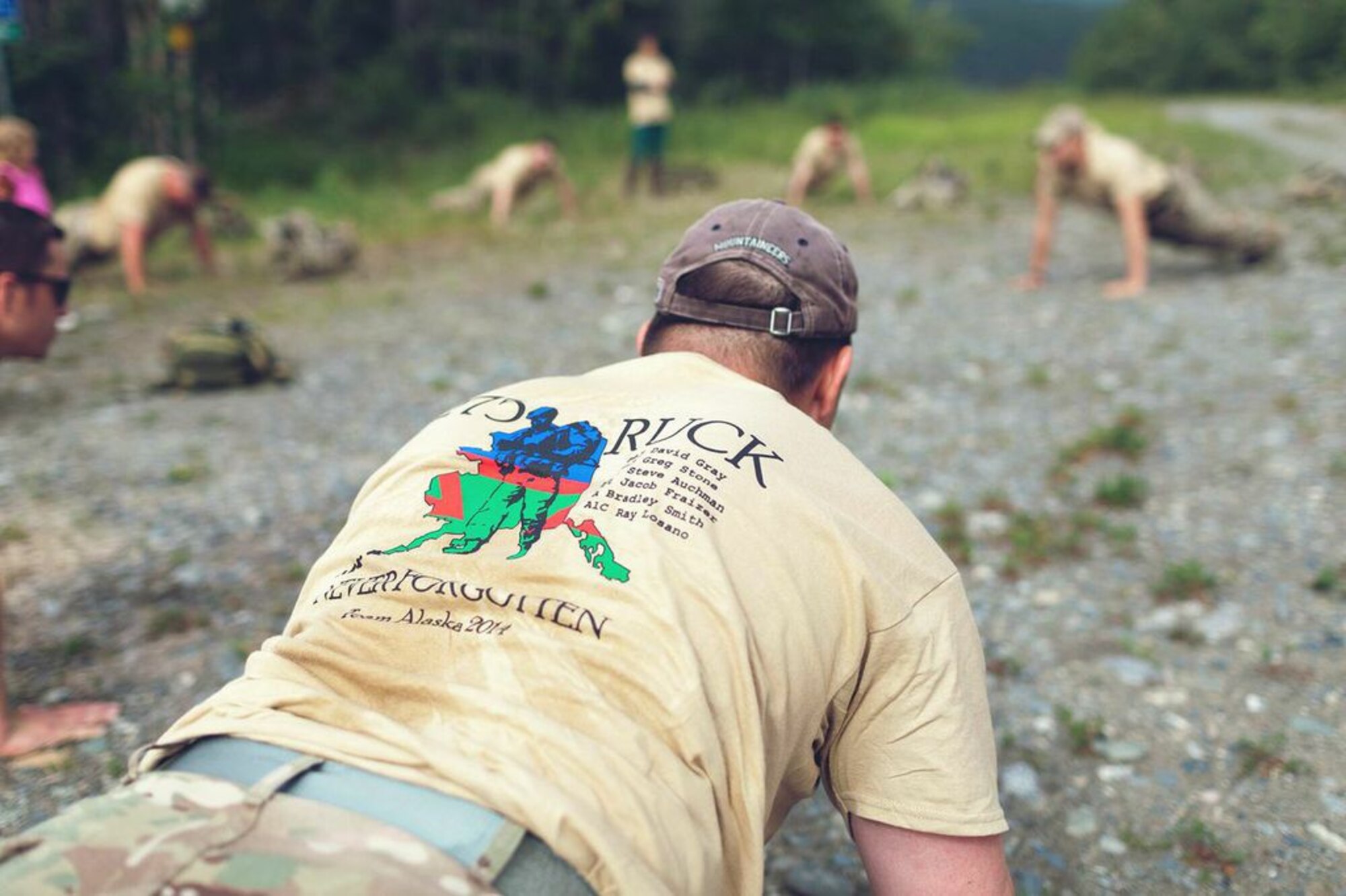 U.S. Airmen with the Tactical Air Control Party 3rd Air Support Operations Squadron assigned to Fort Wainwright and Joint Base Elmendorf-Richardson, do memorial push-ups after a 275 mile ruck, July 18, 2014, Paxson, Alaska. The memorial push-ups were in remembrance of fallen TACP brothers after four and a half days of rucking along the Denali Highway. (Courtesy Photo by Senior Airman Stephan Phan)
