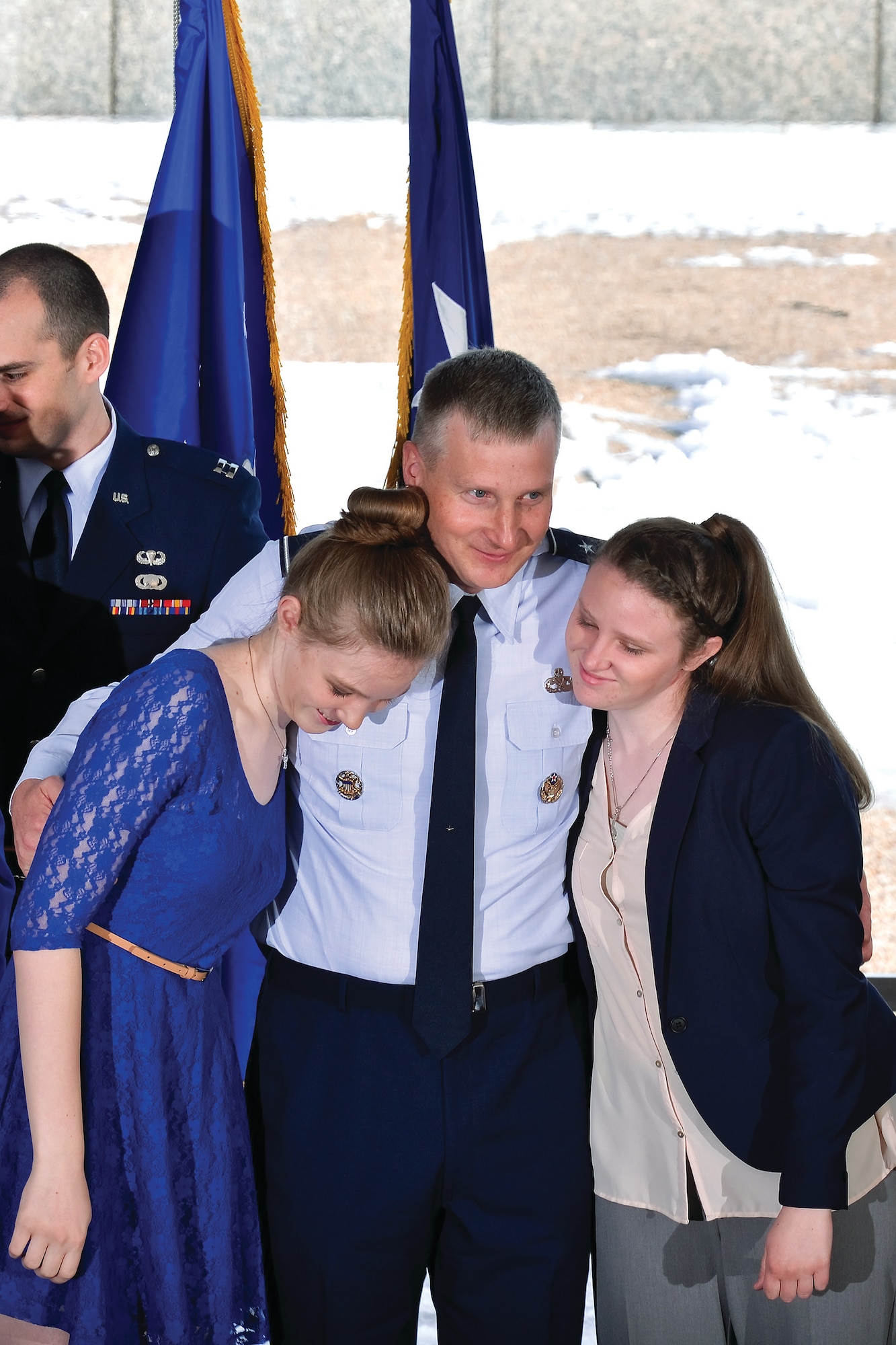 Brig. Gen. Evan Miller, the Academy’s vice superintendent, hugs his daughters Maleah (left) and Audra (right), during his April promotion ceremony here. (U.S. Air Force photo/Liz Copan)