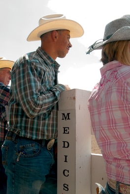 Second Lt. Pat Cunningham, 153rd Medical Group, keeps an eye on the Cheyenne Frontier Days Daddy of ‘em All Rodeo to look out for medical emergencies July 19, 2014. Cunningham and other Airmen volunteered during the rodeo to serve as Cowboy Medics, a group of medical and emergency response professionals ready to handle almost any injury or medical situation that arises at Frontier Park during CFD. (U.S. Air Force photo by Airman 1st Class Jason Wiese)