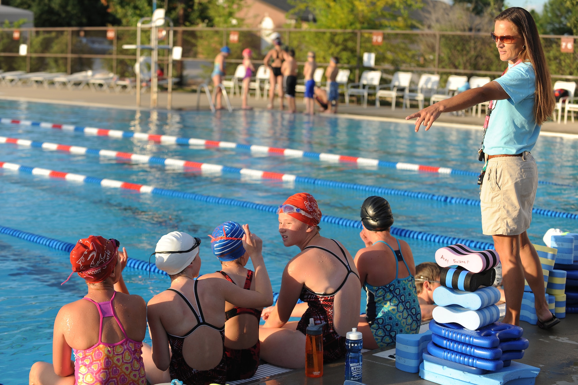 Sharon Wilda mentors swimmers about swimming techniques at Scott Air Force Base, Ill., July 16, 2014.  During swim practice, swimmers work on improving their freestyle, butterfly stroke, back stroke, and breast stroke.  Wilda is a coach for the Scott Sharks.  (U.S. Air Force photo by Staff Sgt. Maria Bowman)
