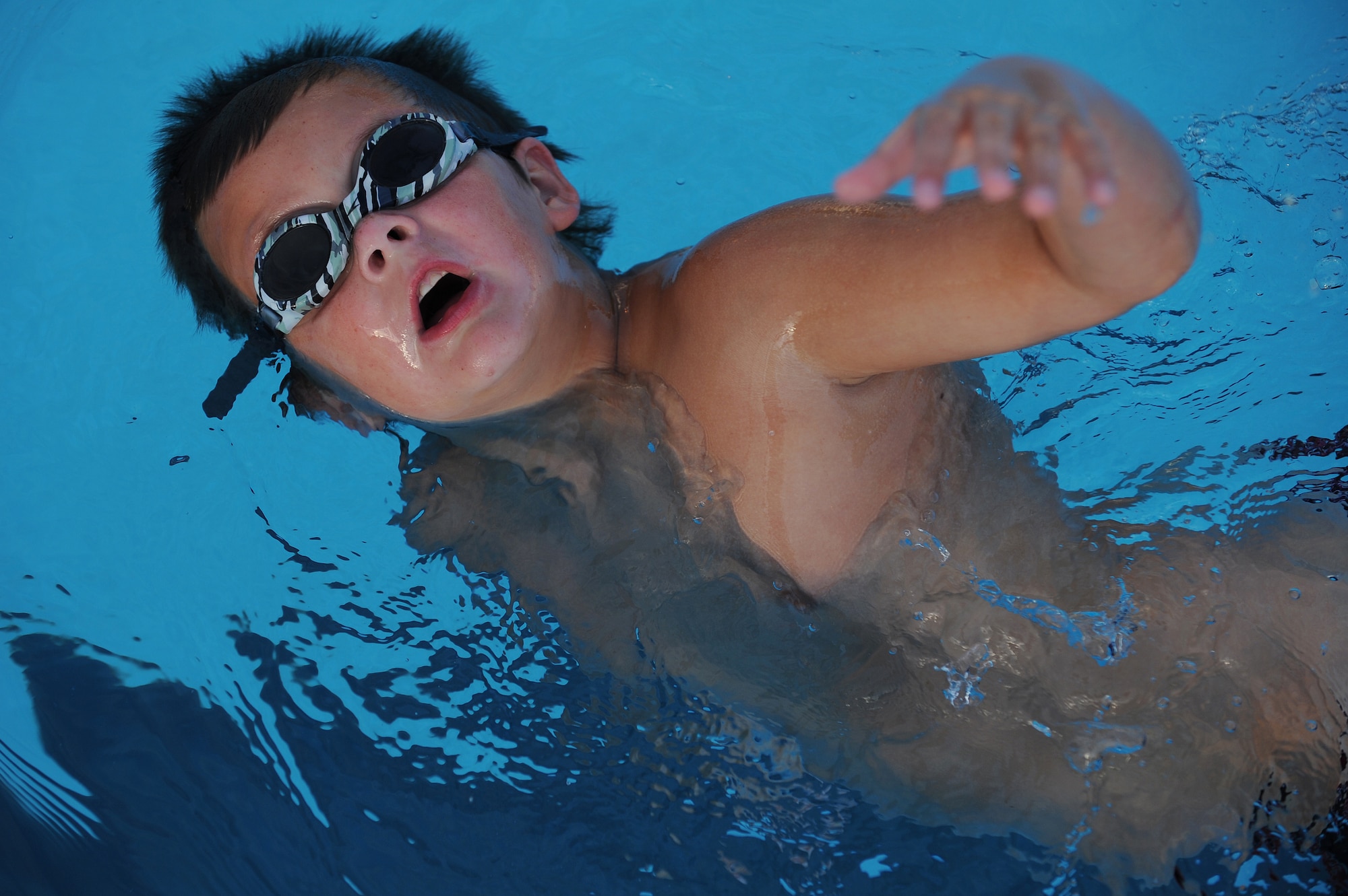 Ethan Sheldon works on side breathing during swim practice at Scott Air Force Base, Ill., July 16, 2014.  During freestyle, swimmers need to develop good breathing techniques, so their body position remains correct and their strokes don’t become lopsided.  Sheldon is a swimmer for the Scott Sharks.  (U.S. Air Force photo by Staff Sgt. Maria Bowman)