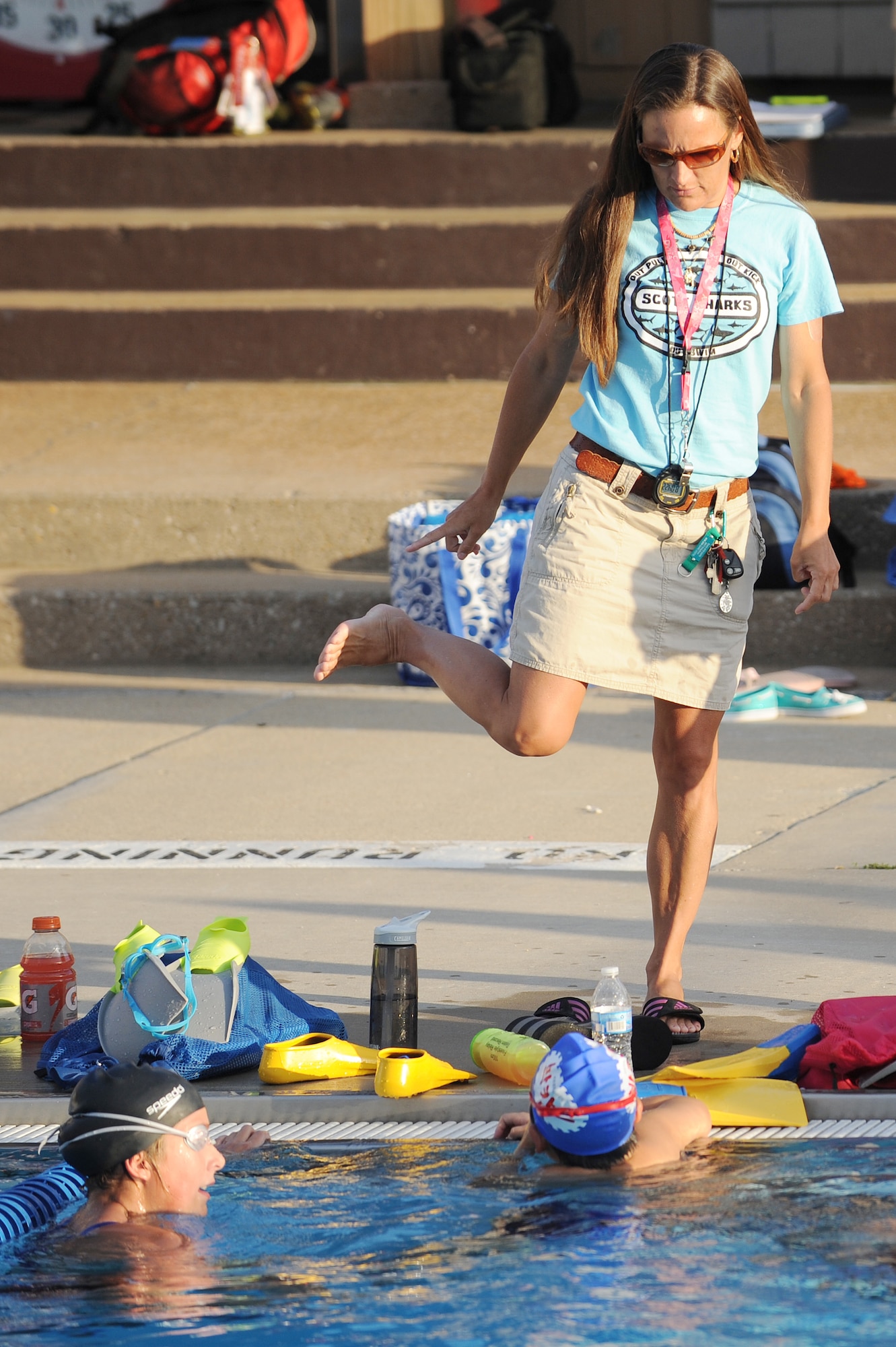 Sharon Wilda gives instructions on breaststroke techniques at Scott Air Force Base, Ill., July 16, 2014.  The breaststroke is swum in on the stomach, with both arms moving synchronously and executing short, half-circular movements underwater. The legs also move synchronously and execute a whip kick.   At a competition level, breaststroke swimmers will have to have endurance and strength to move quickly.  Wilda is a coach for the Scott Sharks.  (U.S. Air Force photo by Staff Sgt. Maria Bowman)