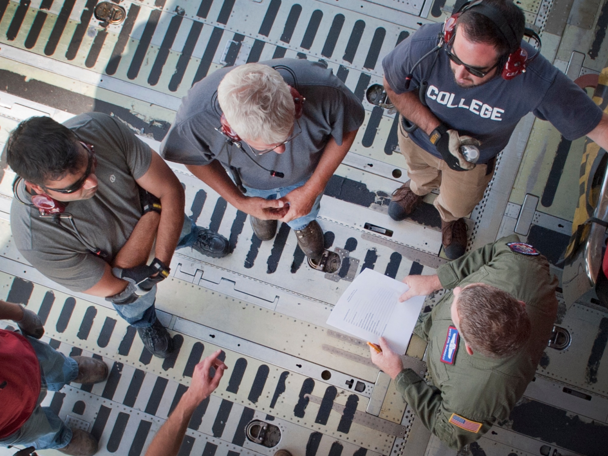 Master Sgt. Philip Magreevy, 22nd Airlift Squadron NCO-in-charge of loadmaster standardization and evaluation, and members of the NASA team go over the plan to unload the Pathfinder from the C-5C Galaxy at Joint Base Andrews, Md., July 17, 2014.  The 22nd Airlift Squadron is from Travis Air Force Base, Calif. (U.S. Air Force photo/Staff Sgt. Torey Griffith)