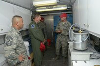 Tech. Sgt. David Jauch, 820th Rapid Engineer Deployable Heavy Operational Repair Squadron Engineer Squadron from Nellis Air Force Base, Nevada, engineering assistant craft lead briefs Gen. Robin Rand, commander of Air Education and Training Command, and Chief Master Sgt. Gerardo Tapia, AETC command chief master sergeant, on material testing equipment July 22 at Joint Base San Antonio-Randolph's Seguin Auxiliary Airfield.  The 820th RED HORSE team members are constructing a new runway at the airfield. The 12th Flying Training Wing, from JBSA-Randolph, uses the airfield in its instructor pilot training mission, though that training has been suspended until completion of the project. The project, which will cost about $10 million, started May 1 and is scheduled to end Oct. 31. (U.S. Air Force photo by Joel Martinez/Released)