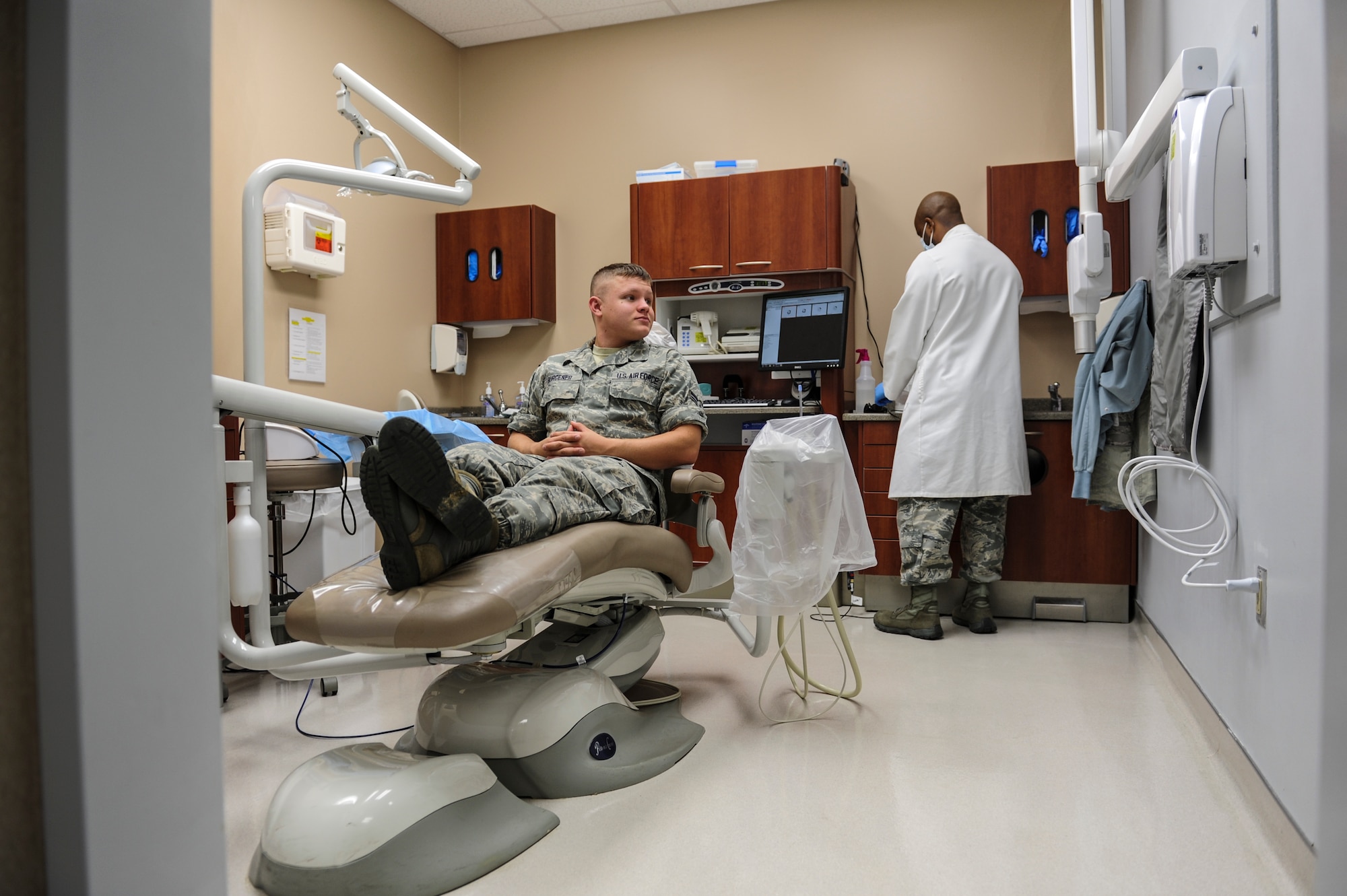 Airman 1st Class Jacob Burgener, a 53rd Airlift Squadron crew chief, chats with his dental care representative about the health of his teeth July 10, 2014, at Little Rock Air Force Base, Ark. Dentist suggest that you brush at least twice daily and floss every night. (U.S. Air Force photo by Airman 1st Class Cliffton Dolezal)