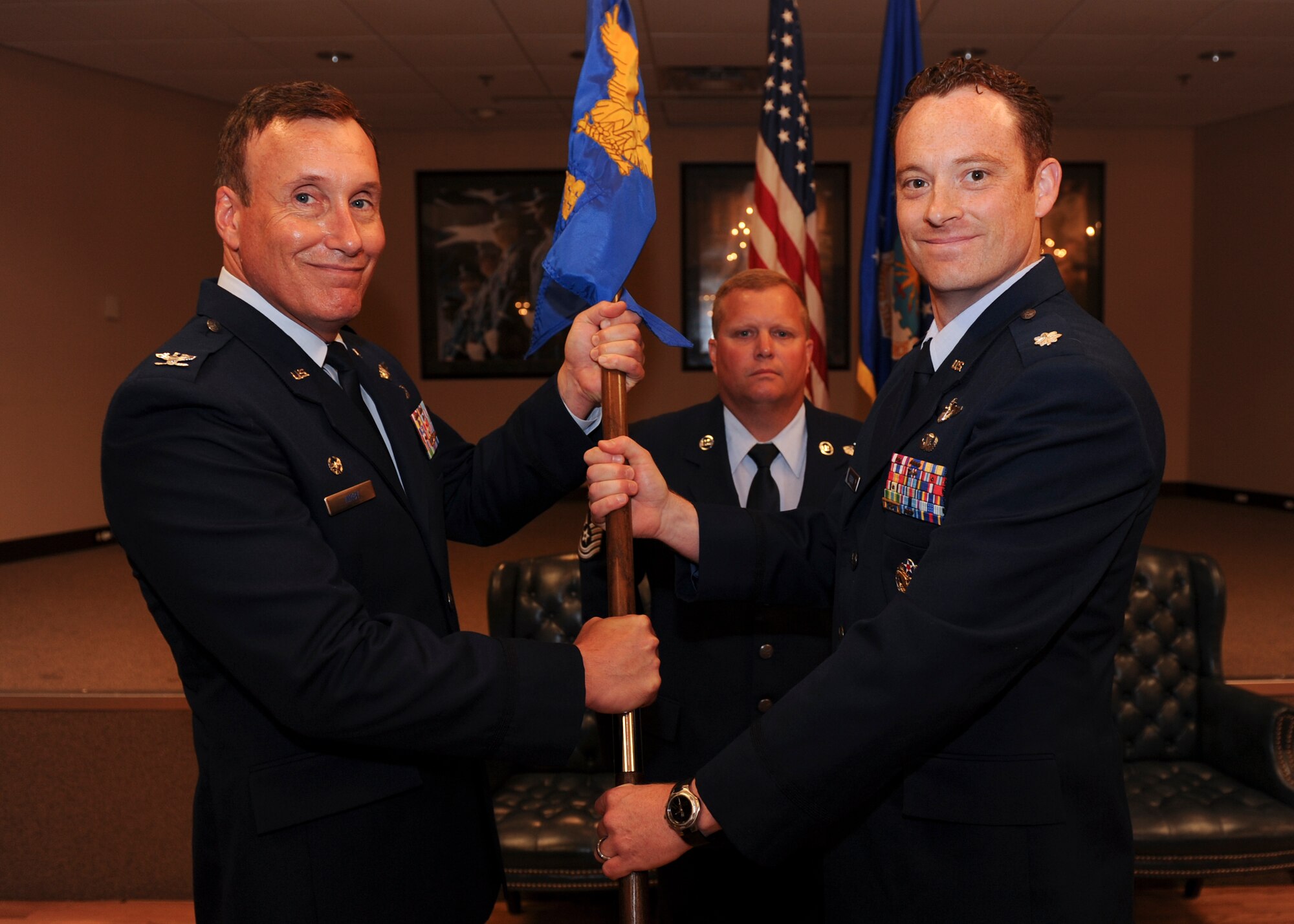 Col. Kelley Kirby, 19th Operations Group deputy commander, passes the guidon to Lt. Col. Daniel Brown, Operations Support Squadron commander, July 7, 2014, at Little Rock Air Force Base, Ark. (U.S. Air Force photo by Airman 1st Class Cliffton Dolezal) 