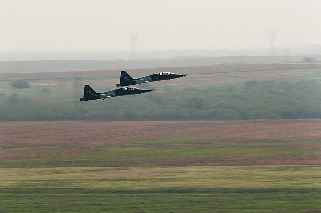 Pilots from the 80th Flying Training Wing, Sheppard Air Force Base, Texas, practice touch and go maneuvers in a T-38 Talon aircraft during training July 24, 2013. The Talon is a two-seat, twin-engine supersonic jet trainer used to train pilots in the international Euro-NATO Joint Pilot Training Program. (U.S. Air Force Photo/Danny Webb/Released)