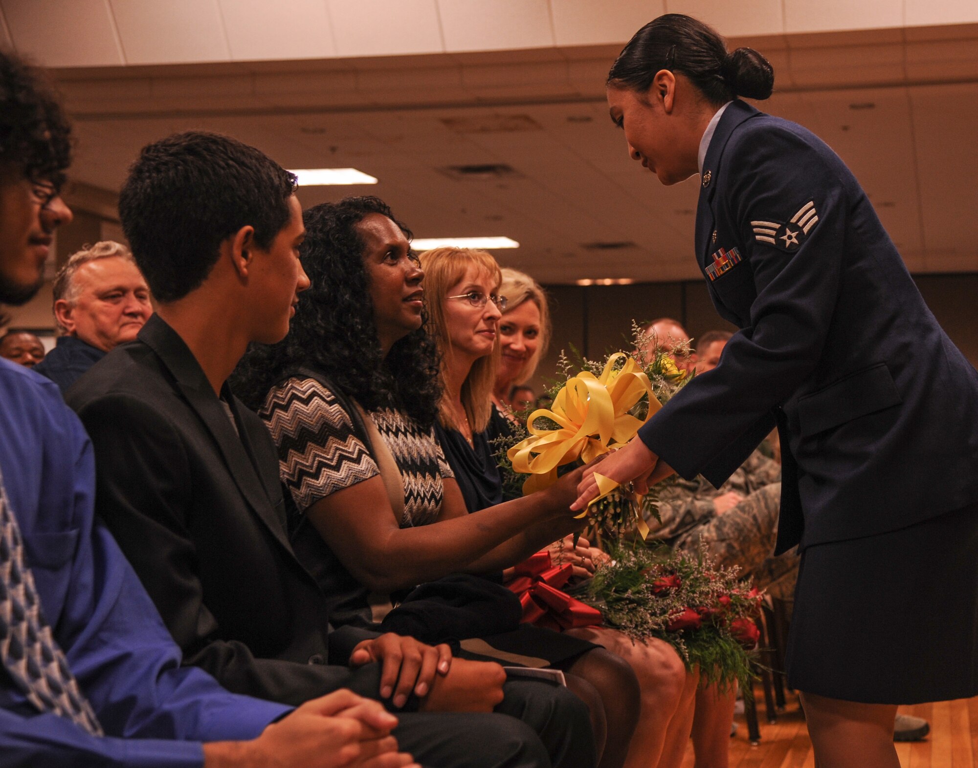 Angelica Punla, a 19th Medical Support Squadron pharmacy technician, presents flowers to the wife of Lt. Col. Dean Farrey, 19th Medical Support Squadron commander, July 21, 2014, at Little Rock Air Force Base, Ark