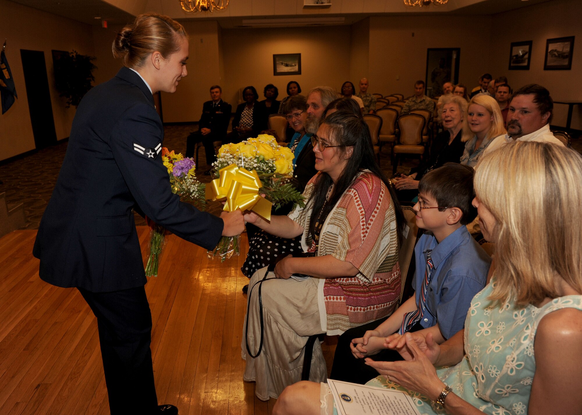 Flowers are presented to the wife of Maj. Jamey Hartsel, 19th Contracting Squadron commander, during the 19th CONS change of command ceremony July 16, 2014, at Little Rock Air Force Base, Ark. (U.S. Air Force photo by Airman 1st Class Scott Poe)