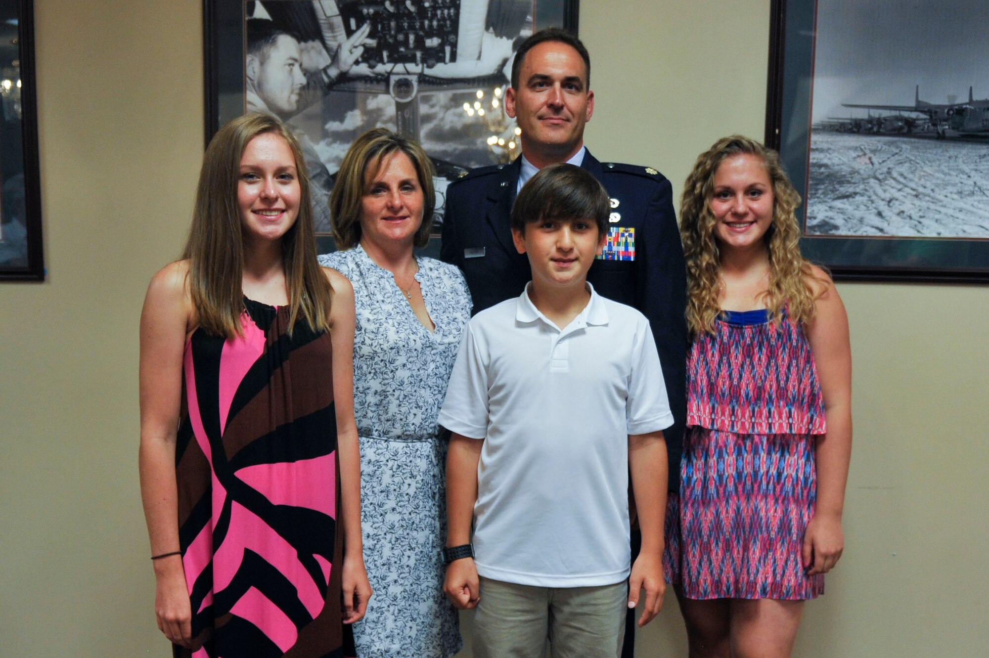 The Hickam family poses for a photo after a ceremony where Maj. Michael Hickam, 19th Comptroller Squadron commander, assumed command July 10, 2014, at Little Rock Air Force Base, Ark. (U.S. Air Force photo by Senior Airman Regina Agoha)