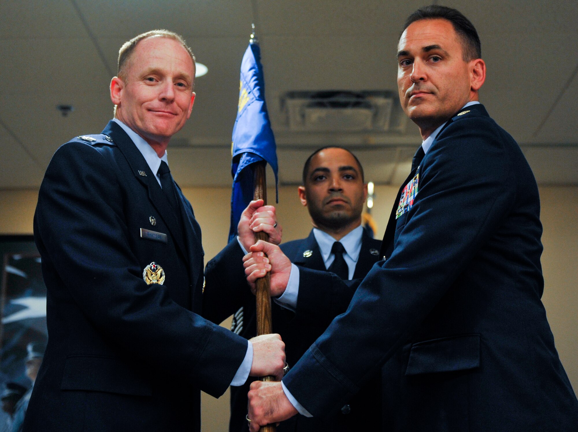 Col. Patrick Rhatigan, 19th Airlift Wing commander, passes the guidon to Maj. Michael Hickam, 19th Comptroller Squadron commander, July 10, 2014, at Little Rock Air Force Base, Ark. (U.S. Air Force photo by Senior Airman Regina Agoha)