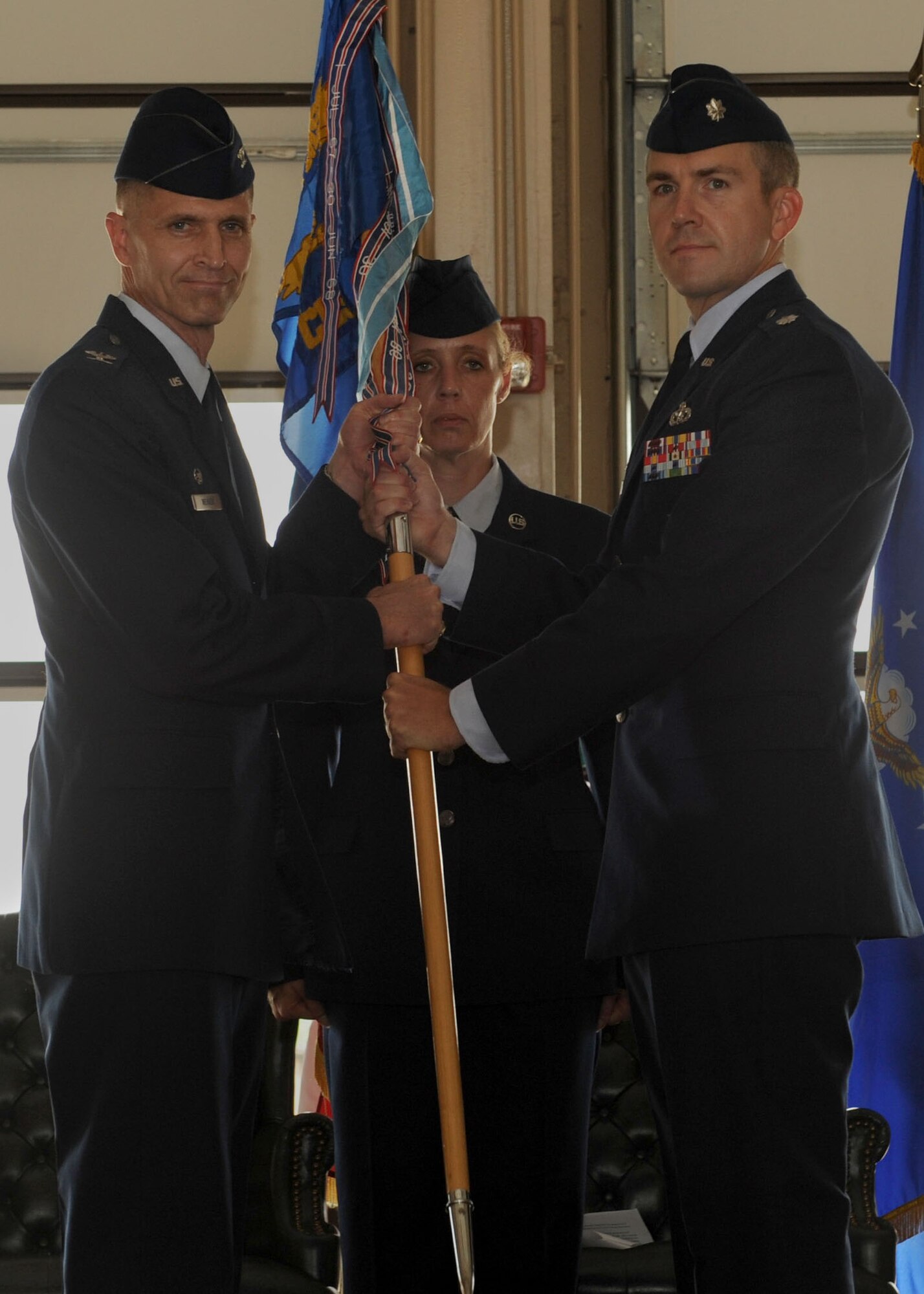 Col. Stephen Weaver, 19th Maintenance Support Group commander, passes the guidon to Lt. Col. Michael Klapmeyer, 19th Civil Engineer Squadron commander, July 11, 2014, at Little Rock Air Force Base, Ark.  (U.S. Air Force photo by Airman 1st Class Scott Poe)