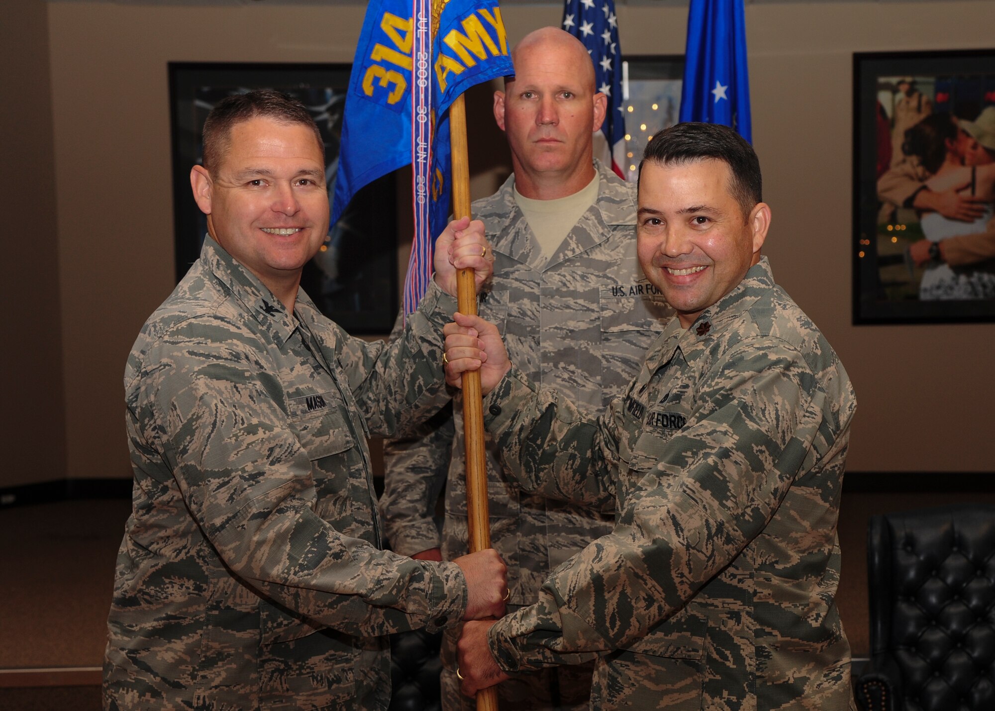 Col. Clay Mason, 314th Maintenance Group commander, passes the guidon to Maj.Darren Brumfield, 314th Aircraft Maintenance Squadron, July 8, 2014, at Little Rock Air Force Base, Ark. (U.S. Air Force photo by Senior Airman Kaylee Clark)
