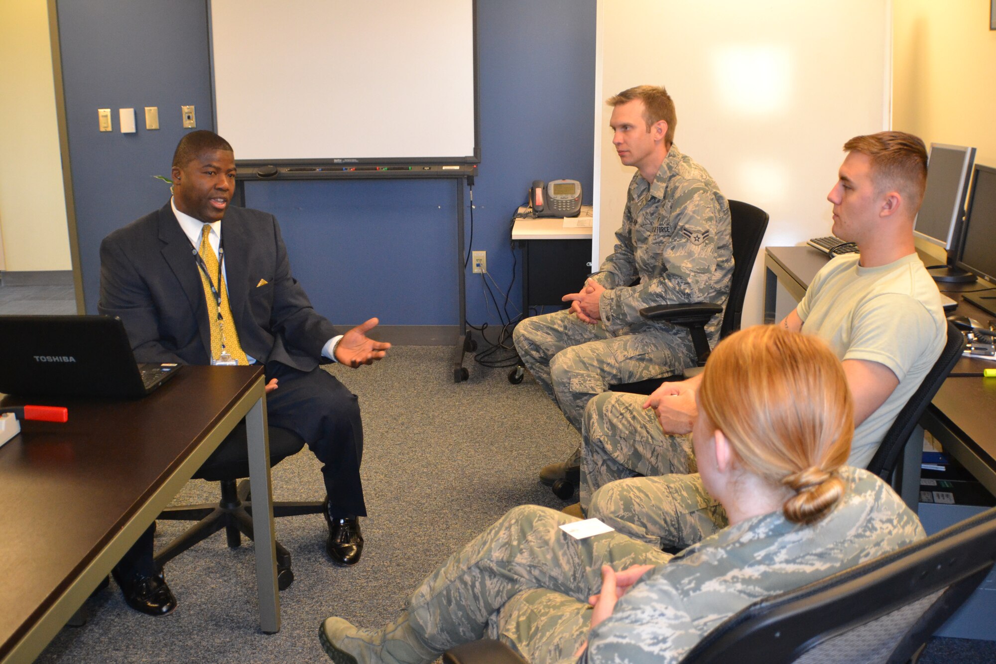 Federal Aviation Administration air traffic controller, Marvin Sutton, from the Air Route Traffic Control Center in Fort Worth, Texas, talks with Airmen from the 319th Operations Support Squadron on June 3, 2014, inside one of the classrooms inside the air traffic control tower on Grand Forks Air Forks Air Force Base, N.D. Among several things, Sutton spoke about the differences he noticed when he transitioned from being an Air Force air traffic controller to a civilian one in 1988, and about future job vacancies that may open up for air traffic controllers in civilian sector. (U.S. Air Force photo/Staff Sgt. Luis Loza Gutierrez)