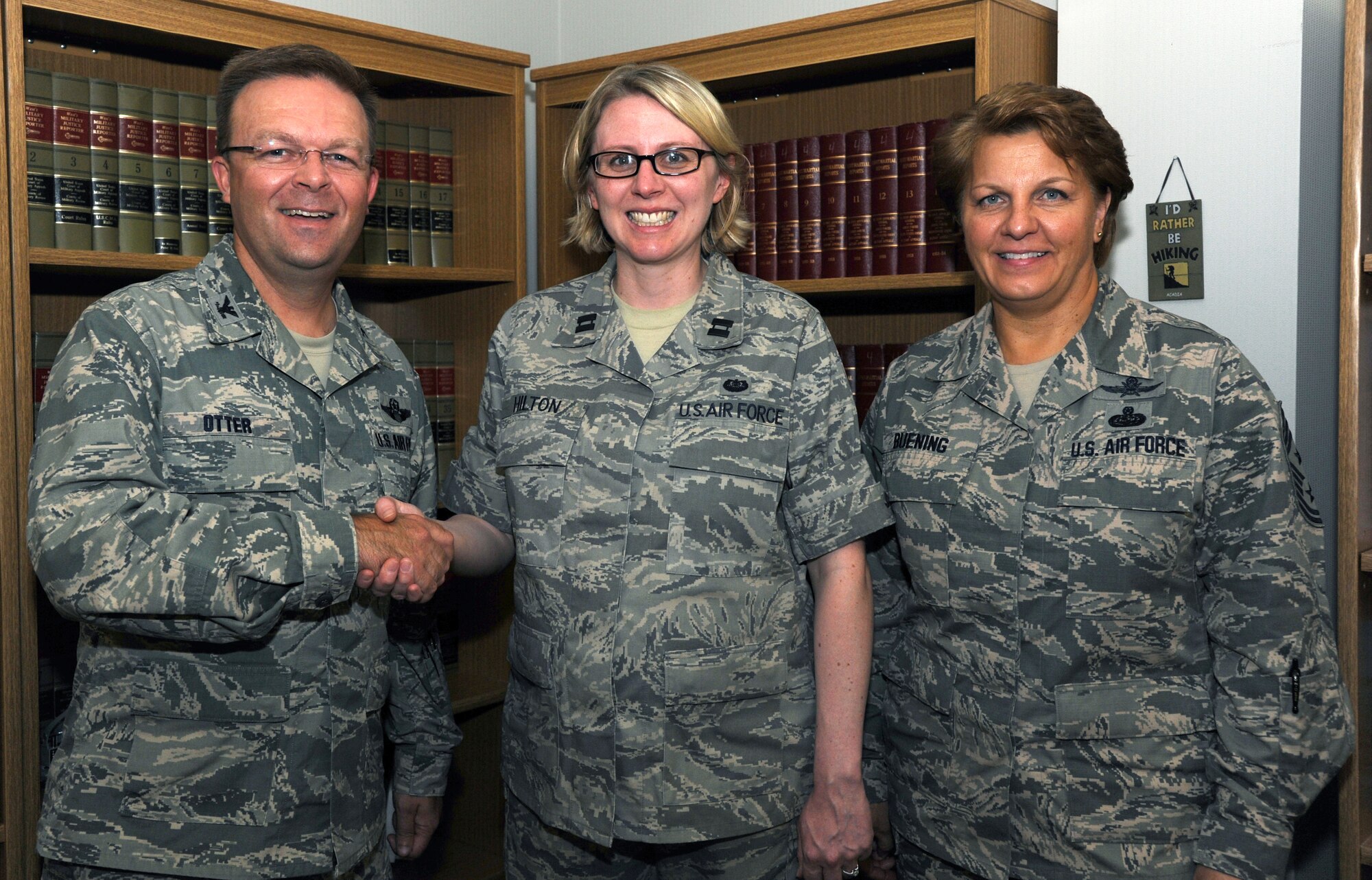 Col. William Otter, 19th Airlift Wing vice commander, and Chief Master Sgt. Rhonda Buening, 19th AW command chief, congratulate Capt. Theresa Hilton, Air Force Legal Operations Agency Area Defense Counsel, for her selection as Combat Airlifter of the Week July 21, 2014, at Little Rock Air Force Base. Hilton manages and provides legal defense services for all active duty members on Little Rock AFB.  (U.S. Air Force photo by Airman 1st Class Mercedes Muro)