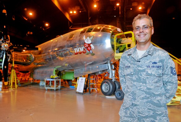 Tech. Sgt. Geoffrey Jensen, 22nd Maintenance Group logistic resource management program NCO in charge, stands in front of ‘Doc,’ a B-29 Superfortress, July 22, 2014, inside a Boeing hangar, in Wichita, Kansas. Jensen joined a volunteer group, Doc's Friends, which is restoring the aircraft to flying condition. (U.S. Air Force photo/Airman 1st Class John Linzmeier)
