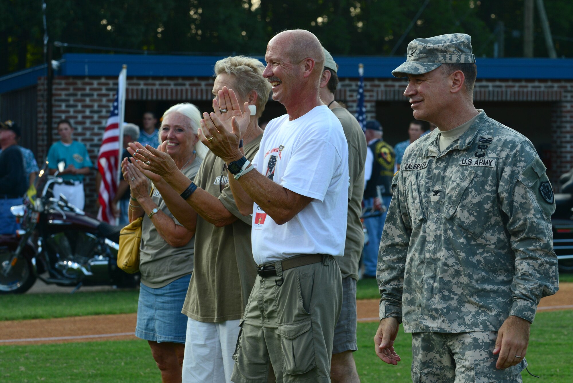 U.S. Army Col. William Galbraith, 733rd Mission Support Group commander, stands on the field of War Memorial stadium with Gold Star Family members during the Peninsula Pilot baseball team’s 2nd Annual Gold Star Family Appreciation Night in Hampton, Va., July 23, 2014. More than 50 family members attended the event which celebrated the lives of their deceased Service members. (U.S. Air Force photo by Airman 1st Class Kimberly Nagle/Released)