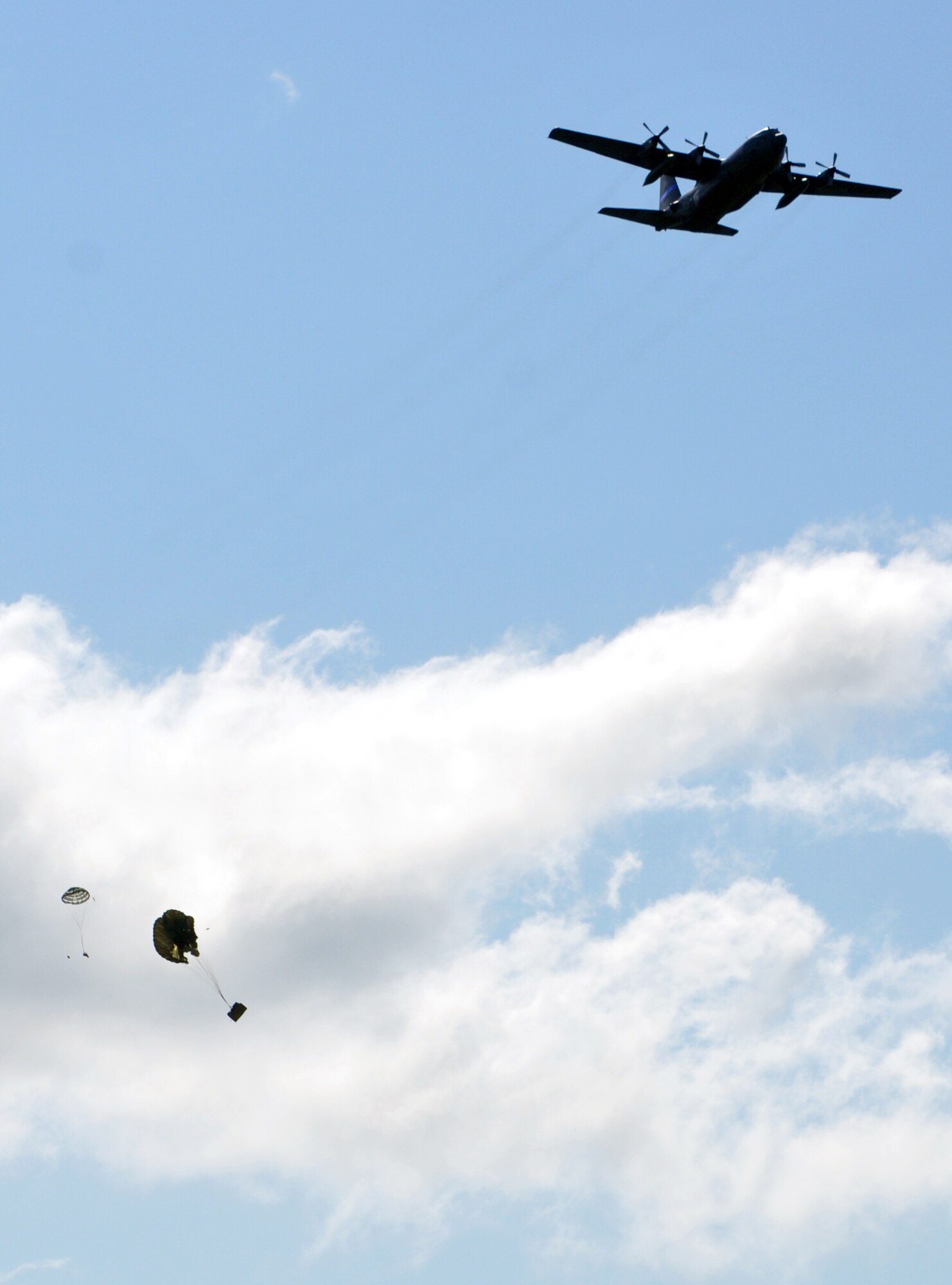 A C-130 from the 192nd Airlift Squadron, part of the Nevada Air National Guard 152nd Airlift Wing, drops various sizes of cargo to perform air drop training missions during the National Guard PATRIOT 2014 exercise at Volk Field, Wis. Several units of the Air National Guard, Army National Guard and Reserve units from several states are working with local, state and national organizations to train on, perform and assess their ability to respond to multiple emergencies.