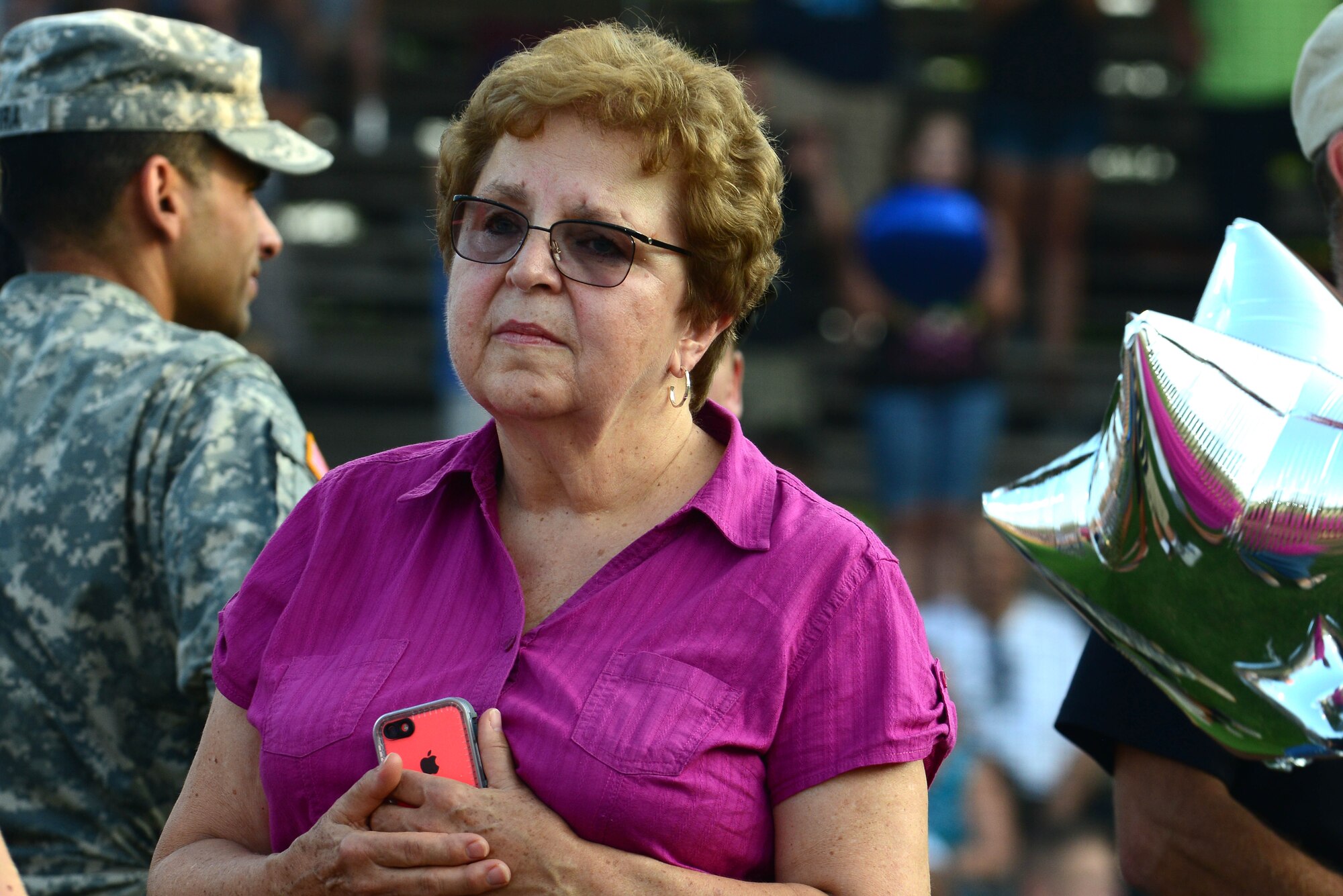 Judy Rynal, mother of the late U.S. Army Sgt. Caryn Nouv, who was killed in action July 27, 2013, reflects on memories of her daughter during the Peninsula Pilot baseball team’s 2nd Annual Gold Star Family Appreciation Night in Hampton, Va., July 23, 2014. The Fort Eustis Gold Star Family program helps families of deceased Service members with funeral planning, finances and counseling services needed to cope with their loss.  (U.S. Air Force photo by Airman 1st Class Kimberly Nagle/Released)