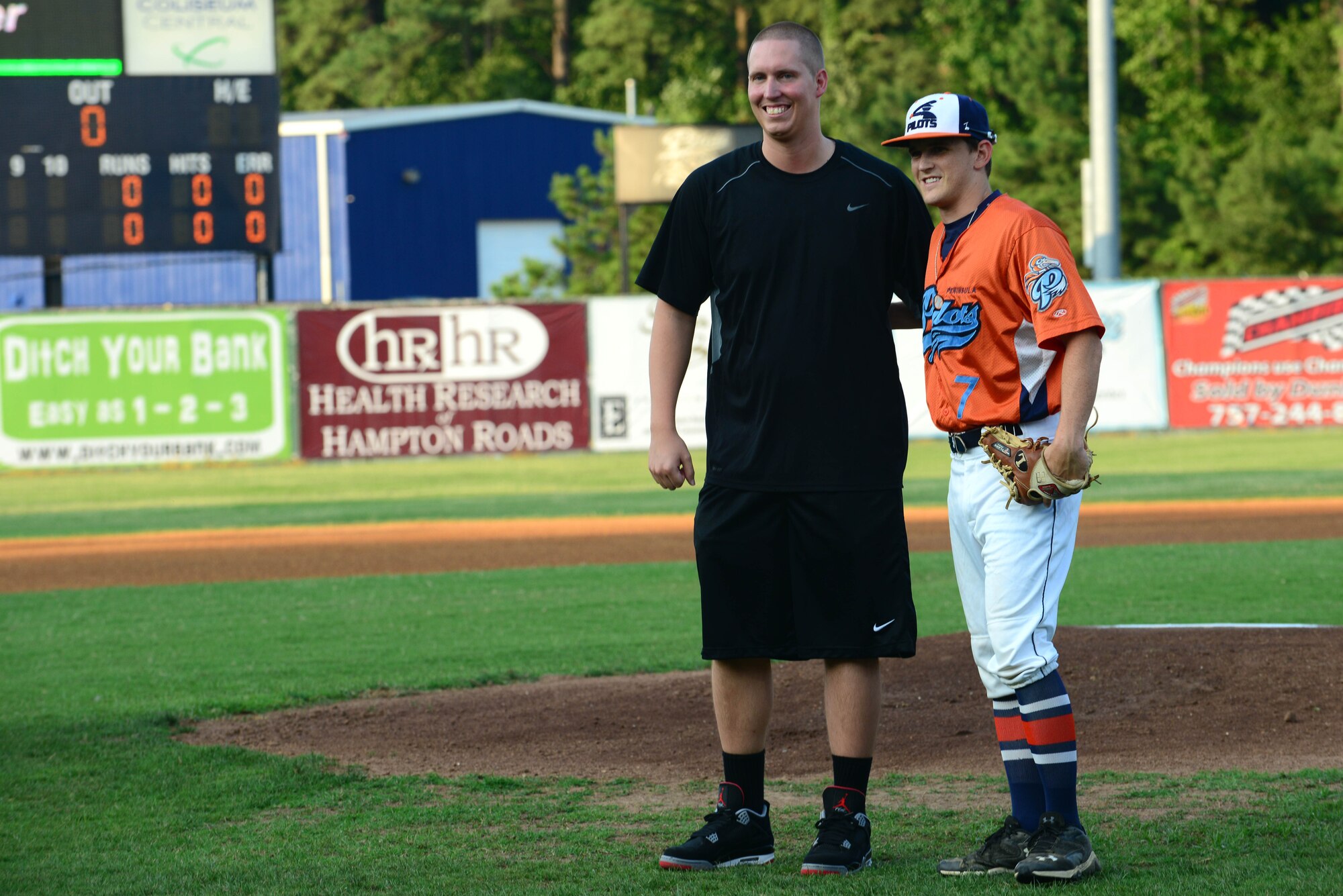 Steve Chambers, left, brother of U.S. Army Sgt. David Chambers who lost his life while on duty Jan. 16, 2013, threw the first pitch during the Peninsula Pilot baseball team’s 2nd Annual Gold Star Family Appreciation Night in Hampton, Va., July 23, 2014. The Gold Star Family program holds events such as Thanksgiving meals and mother’s day activities. (U.S. Air Force photo by Airman 1st Class Kimberly Nagle/Released)