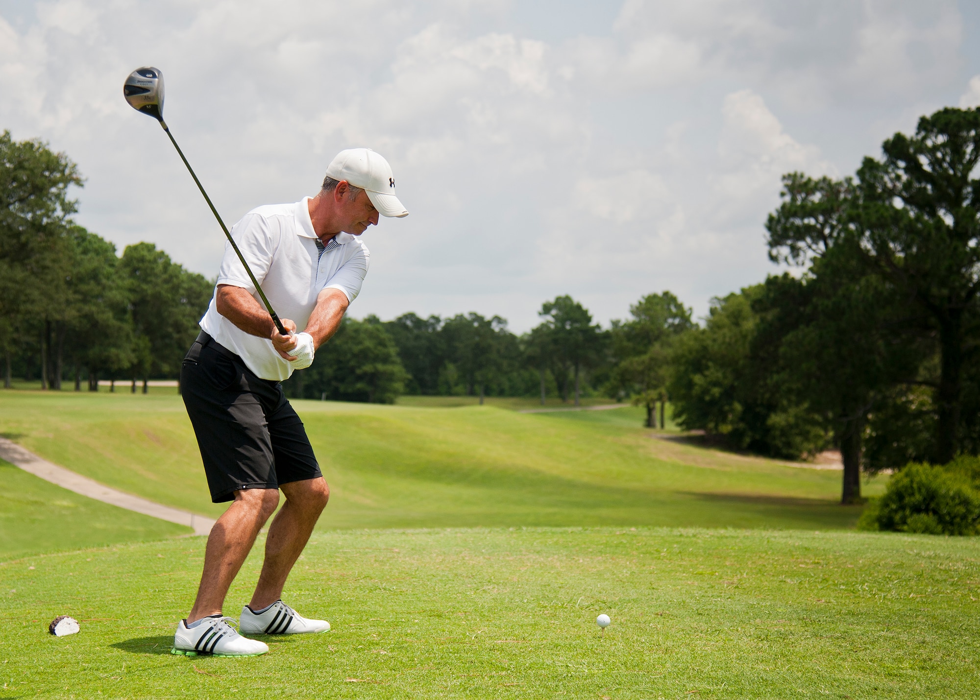 Randy Anderson, with the Air Force Research Lab, prepares to strike the ball at the beginning of the base intramural golf championship July 23 at the Eglin Golf Course.  The AFRL team played against the 53rd Wing team and prevailed to take the championship. (U.S. Air force photo/Ilka Cole)