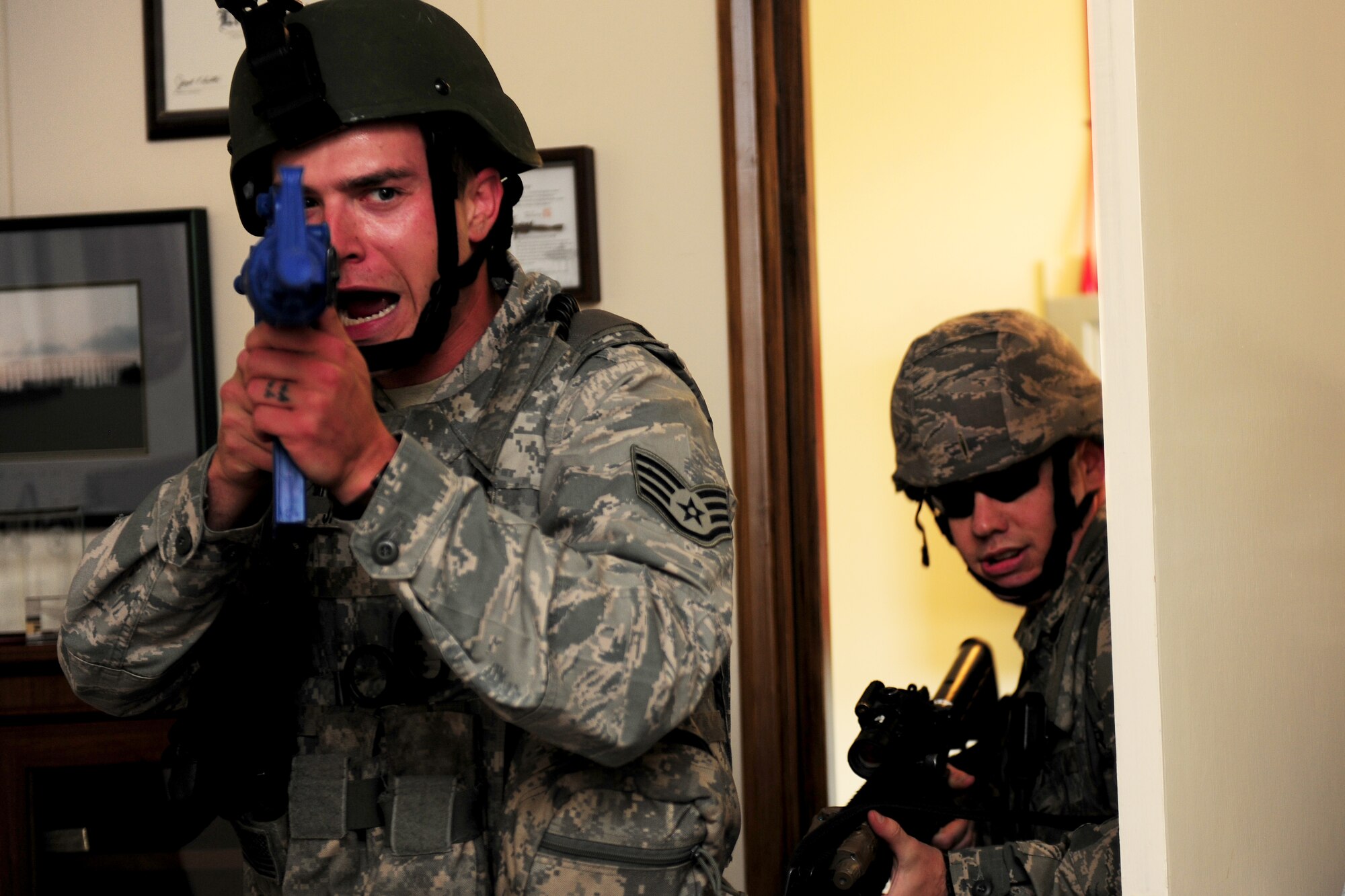 Staff Sgt. Brady Jackson, 422nd Security Forces Squadron patrolman, breaches the office where a simulated-active shooter was hiding during an exercise at RAF Croughton, United Kingdom, July 22, 2014. During the exercise, Security Forces Airmen conducted building sweeps to locate the active shooter and identify survivors and casualties. (U.S. Air Force photo by Staff Sgt. Jarad A. Denton/Released)