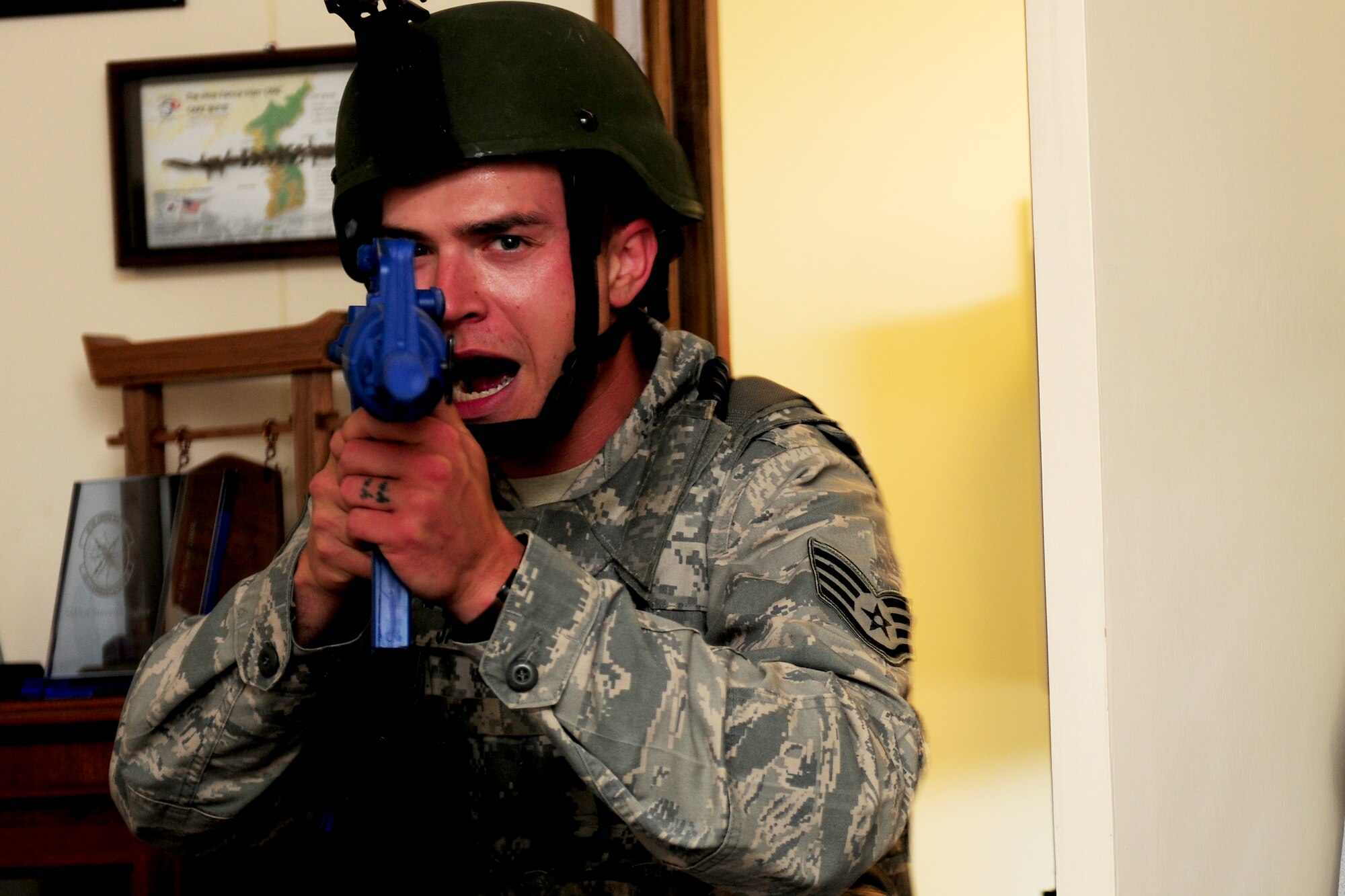 Staff Sgt. Brady Jackson, 422nd Security Forces Squadron patrolman, breaches the office where a simulated-active shooter was hiding during an exercise at RAF Croughton, United Kingdom, July 22, 2014. Security Forces Airmen are specifically trained to resolve active shooter scenarios quickly and efficiently, in order to limit potential casualties. (U.S. Air Force photo by Staff Sgt. Jarad A. Denton/Released)