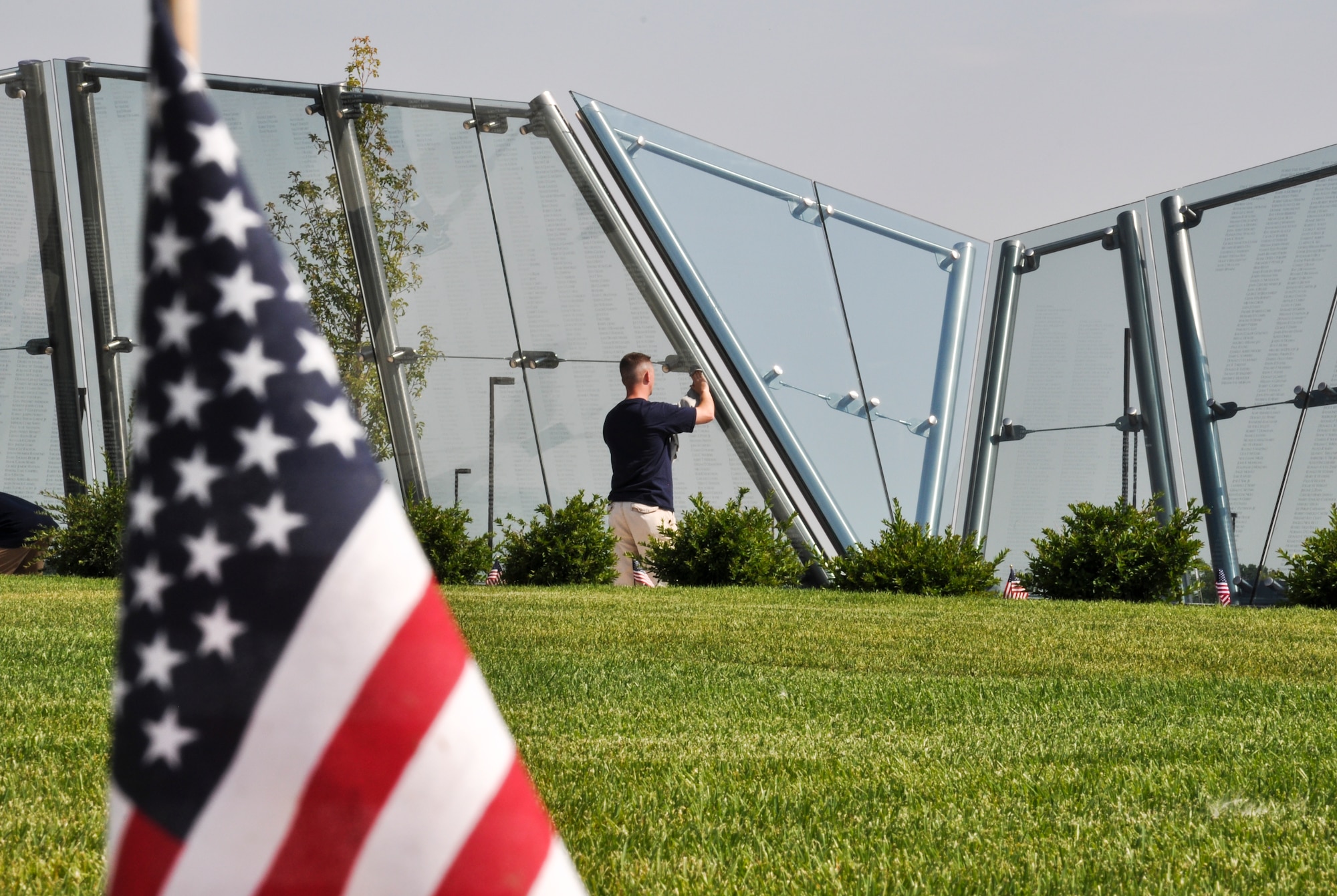 Master Sgt. Jeffrey Scobee, Team Buckley Top 3 member, cleans the Colorado Freedom Memorial July 18, 2014, in Aurora, Colo. Buckley Air Force Base members have begun the new initiative to take care of the memorial at least once every month. (U.S. Air Force photo by Staff Sgt. Nicholas Rau/Released)