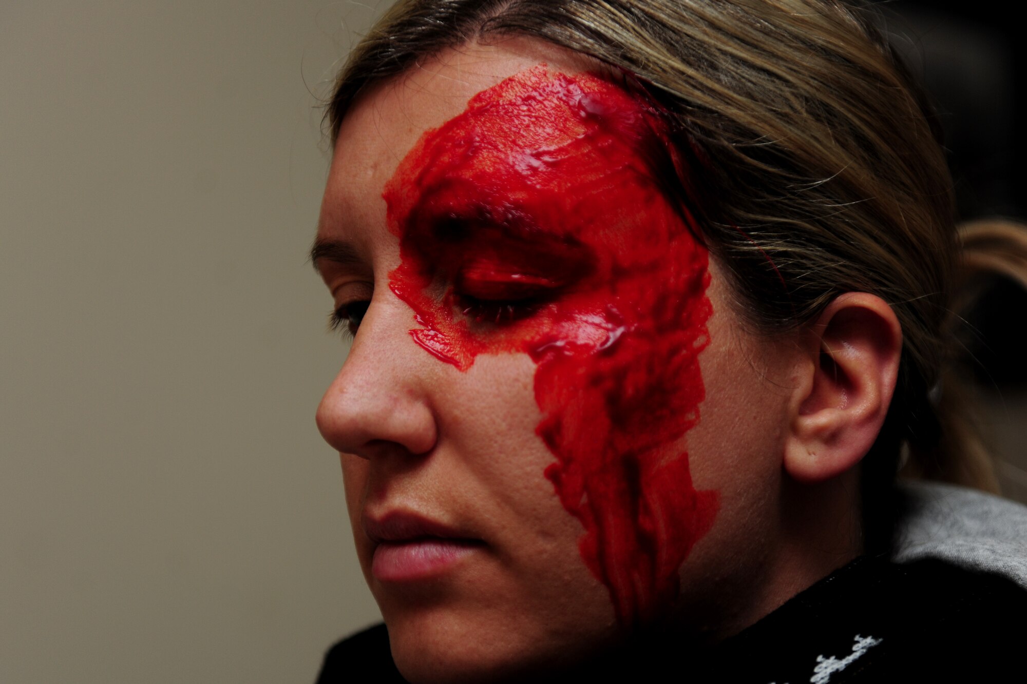 Tech. Sgt. Ajenna Smith, 422nd Security Forces Squadron noncommissioned officer in charge of training and simulated-active shooter, waits for the fake blood from her artificial head wound to properly set during an exercise at RAF Croughton, United Kingdom, July 22, 2014. As an active shooter, Smith said she would have exhibited signs of frustration, anger and isolation that friends and coworkers could have identified prior to the actual rampage. (U.S. Air Force photo by Staff Sgt. Jarad A. Denton/Released)