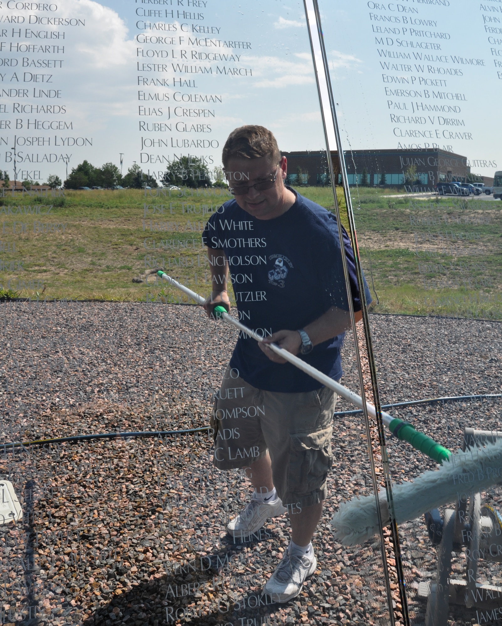 Master Sgt. Robert Holeman, Team Buckley Top 3 member, cleans the Colorado Freedom Memorial July 18, 2014, in Aurora, Colo. Buckley Air Force Base members have begun the new initiative to take care of the memorial at least once every month. (U.S. Air Force photo by Staff Sgt. Nicholas Rau/Released)