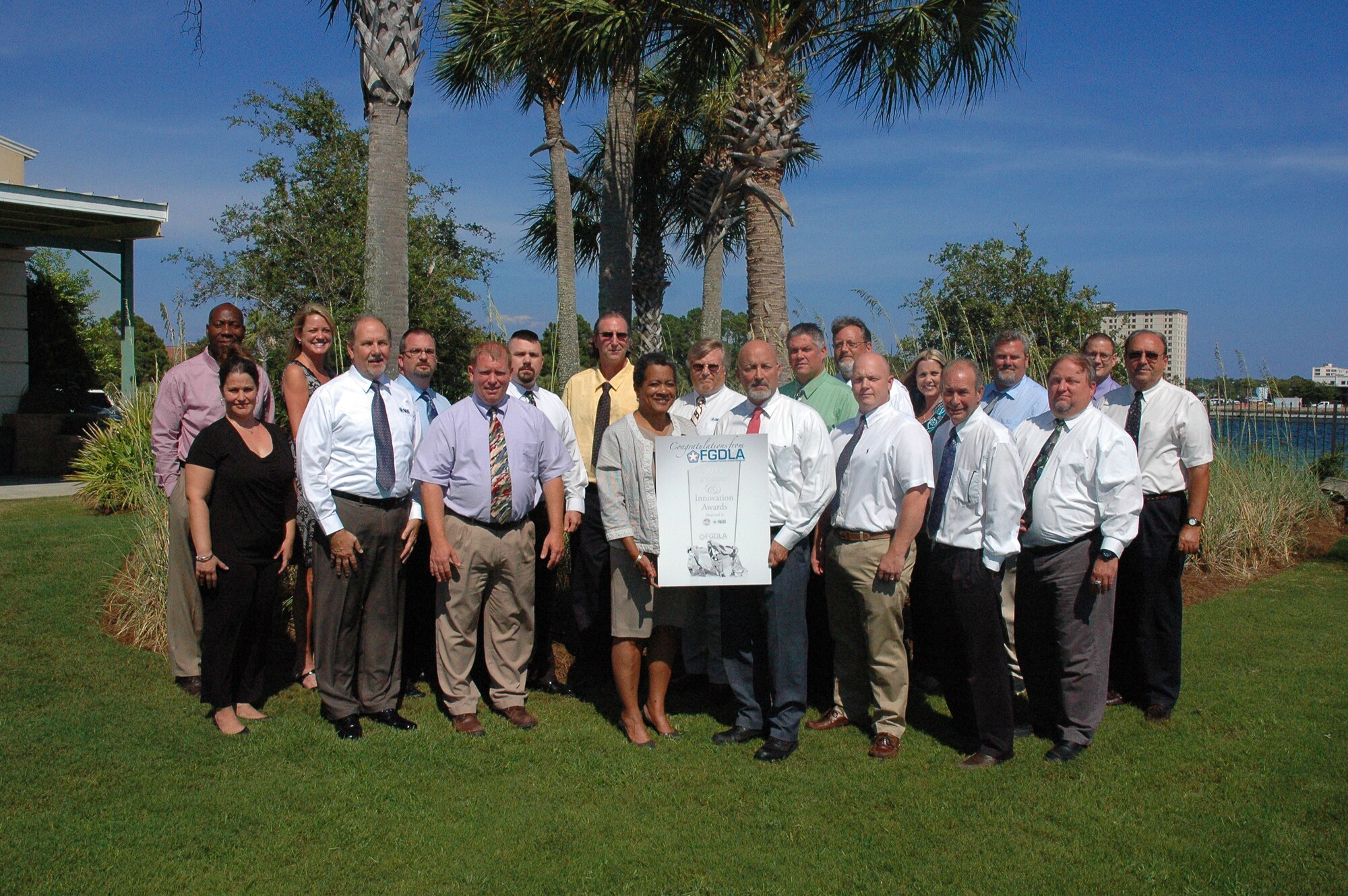 Members of the education and training section gather for a group photo after winning the Federal Government Distance Learning Association's 2014 Innovation Award.  The section, led by Sam Hazzard, won the award for its leadership in developing emerging distance learning technologies to provide enterprise-wide solutions for the federal government. (U.S. Air Force photo/John Burt)