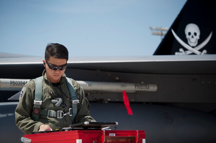 Republic of Singapore air force pilot assigned to the 366th Fighter Wing, 428th Fighter Squadron, Mountain Home Air Force Base, Idaho, reviews F-15SG aircraft maintenance forms as part of a pre-flight inspection prior to a Red Flag 14-3 training mission, July 18, 2014 at Nellis AFB, Nev.  Red Flag is a realistic combat exercise involving U.S. and allied air forces conducting training operations on the 15,000-square-mile Nevada Test and Training Range. (U.S. Air Force photo by Lawrence Crespo)