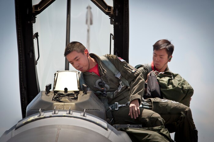 Republic of Singapore air force pilots assigned to the 425th Fighter Squadron, Luke Air Force Base, Ariz., prepare to enter an F-16 Fighting Falcon aircraft prior to a Red Flag 14-3 training mission, July 18, 2014 at Nellis AFB, Nev. Red Flag is an opportunity for U.S. and allied air forces to practice air-to-air combat scenarios to increase their overall combat readiness and efficiency. (U.S. Air Force photo by Lawrence Crespo)