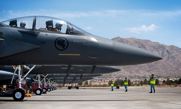 Republic of Singapore air force aircrew and crew chiefs assigned to the 366th Fighter Wing, 428th Fighter Squadron, Mountain Home Air Force Base, Idaho, prepare to launch three F-15SG aircraft during Red Flag 14-3, July 18, 2014 at Nellis AFB, Nev.  Red Flag is an opportunity for U.S. and allied air forces to train together during realistic combat scenarios on the Nevada Test and Training Range north of Las Vegas. (U.S. Air Force photo by Lawrence Crespo)