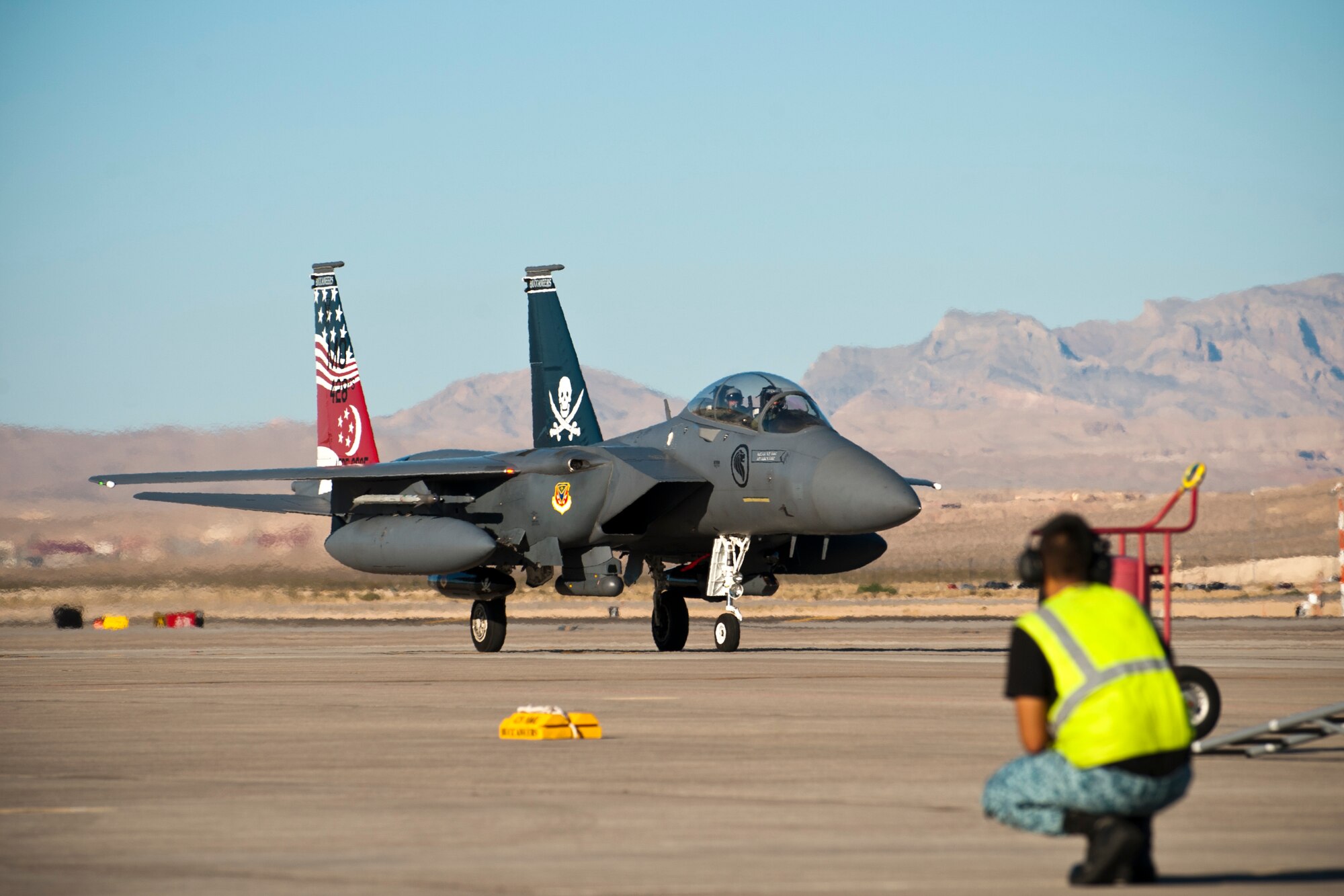 Republic of Singapore air force crew chief assigned to the 366th Fighter Wing, 428th Fighter Squadron, Mountain Home Air Force Base, Idaho, waits for the arrival of an F-15SG aircraft prior to the start Red Flag 14-3, July 11, 2014 at Nellis AFB, Nev.  Throughout the Red Flag exercise, aircraft from more than 16 U.S. Air Force squadrons and the French and Singapore air forces are scheduled to train over the skies of the Nevada Test and Training Range.  (U.S. Air Force photo by Airman 1st Class Thomas Spangler)