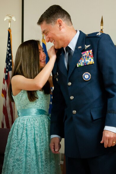 The daughter of Kentucky’s assistant adjutant general for Air, Warren H. Hurst, pins new rank on his uniform during a ceremony promoting Hurst to the rank of brigadier general at the Kentucky Air National Guard Base in Louisville, Ky., July 12, 2014. Hurst previously served as commander of the Kentucky Air Guard’s 123rd Airlift Wing. (U.S. Air National Guard photo by Staff Sgt. Vicky Spesard)